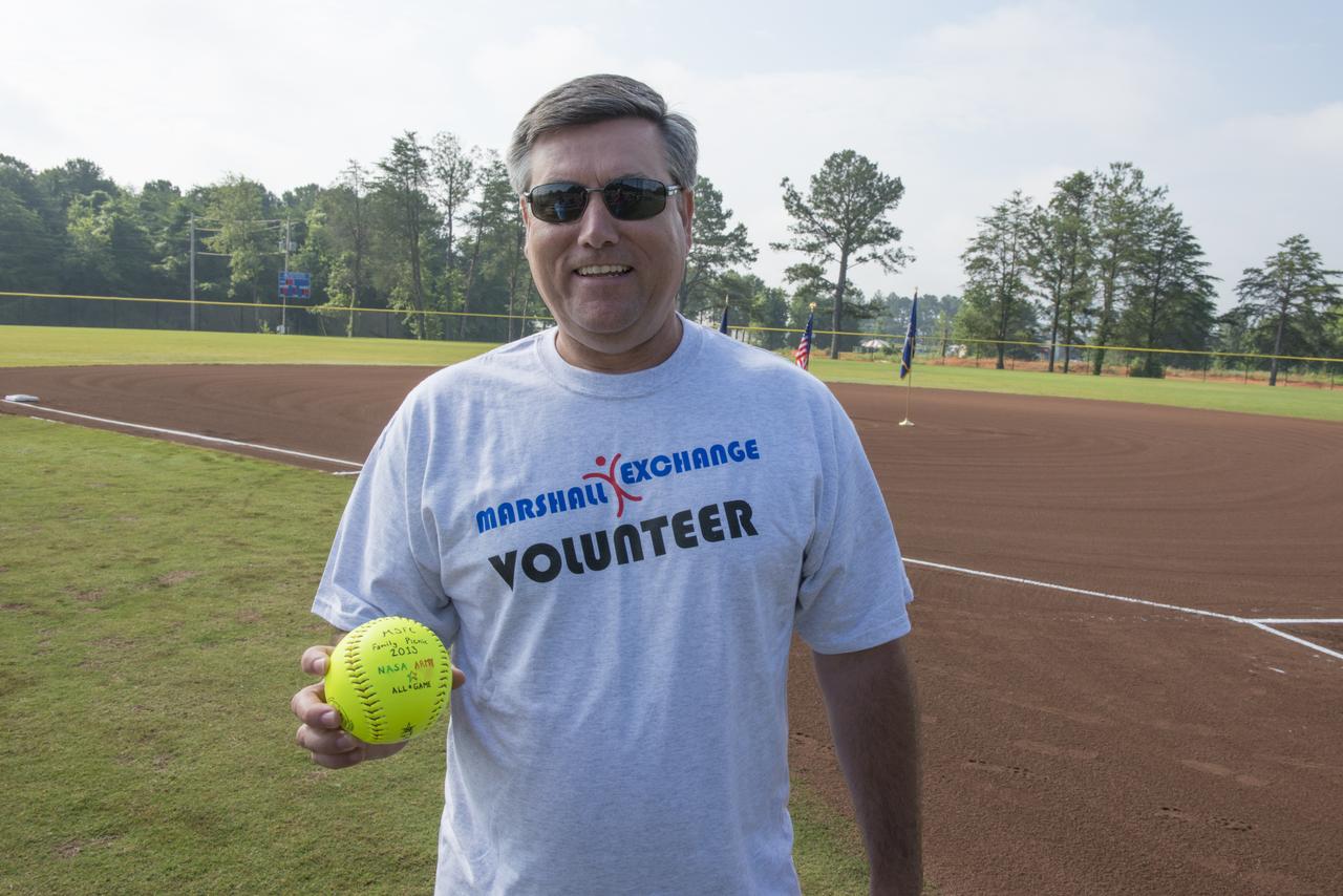 MSFC DIRECTOR PATRICK SCHEUERMANN WITH HIS COMMEMORATIVE SOFTBALL PRESENTED TO HIM BEFORE HE THREW THE FIRST PITCH AT THE NASA VERSUS ARMY SOFTBALL TOURNAMENT AS ONE OF THE 2013 MSFC PICNIC ACTIVITIES