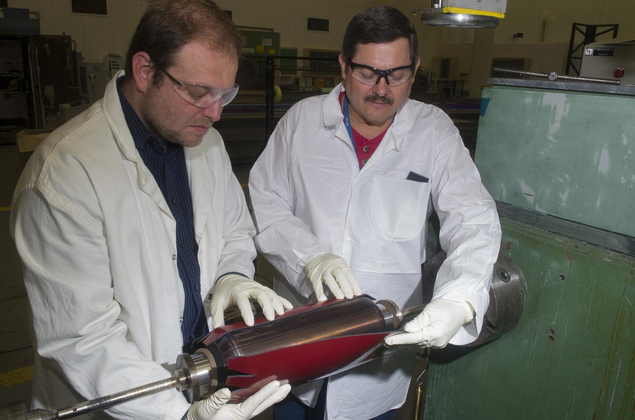 MATERIALS ENGINEER CHAD HASTINGS AND ENGINEERING TECHNICIAN PHILLIP THOMPSON LAYING UP RUBBER INSULATION ON BURST TEST ARTICLE