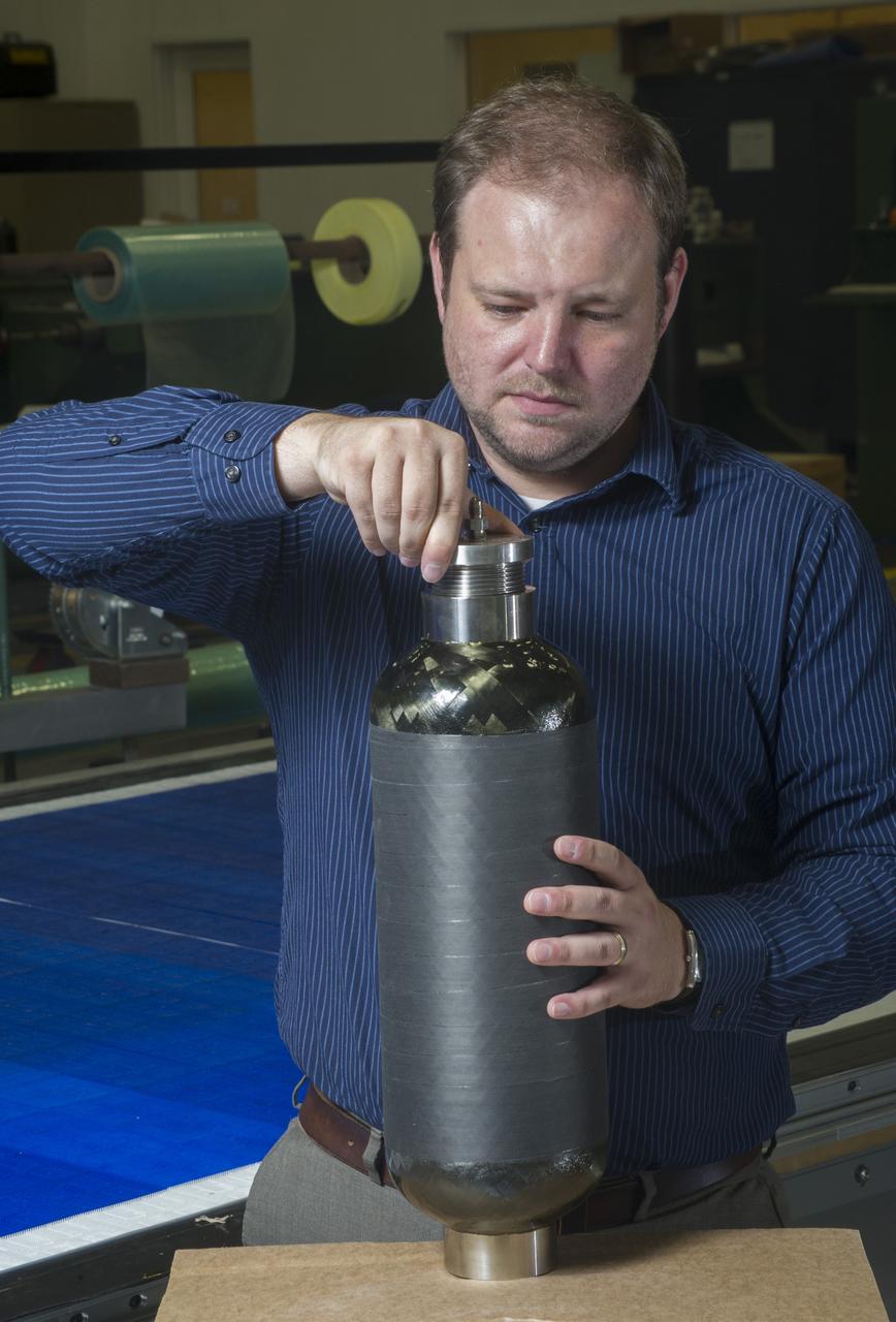 CHAD HASTINGS ATTACHES END FITTING TO BURST TEST ARTICLE