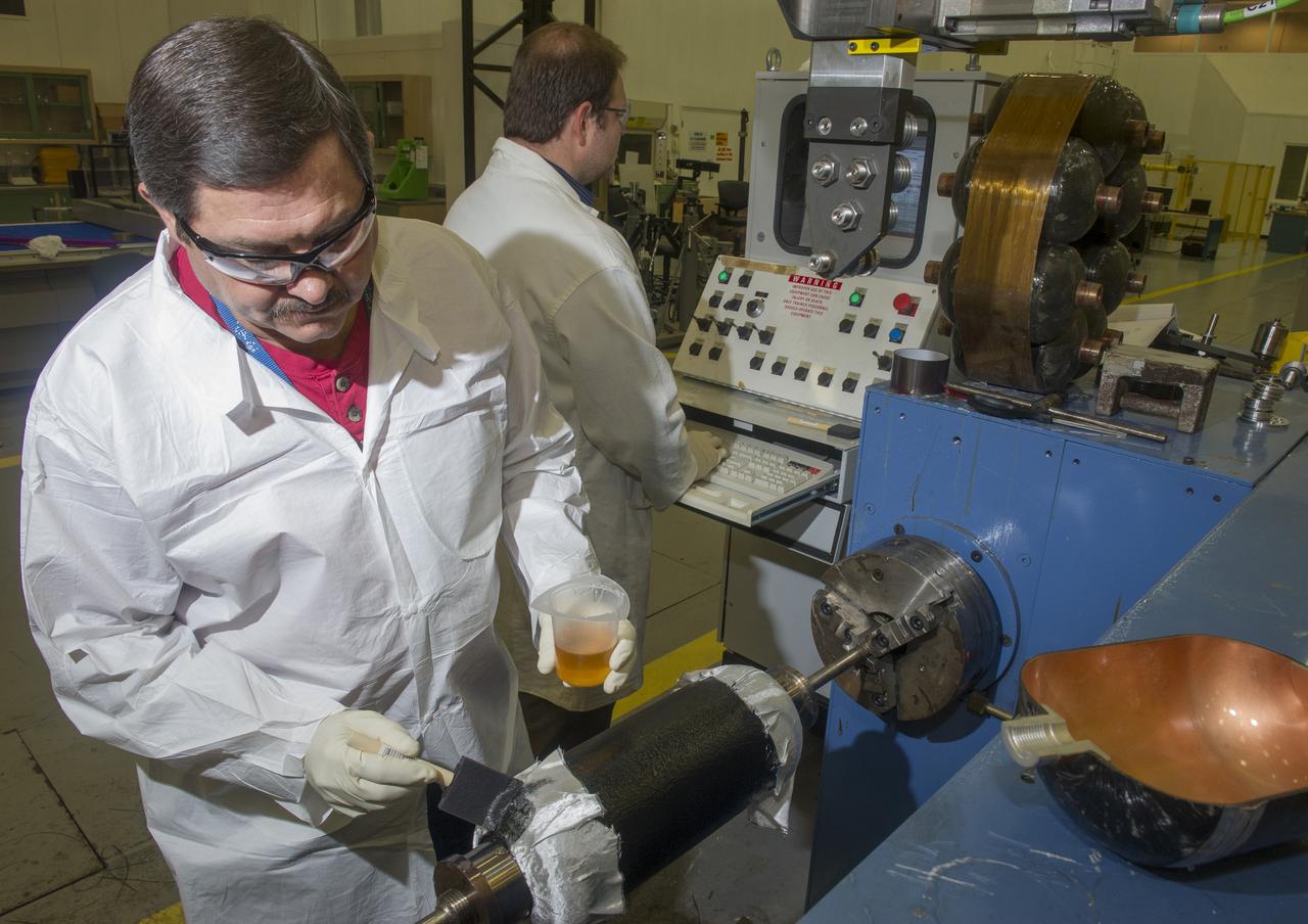PHILLIP THOMPSON APPLIES EPOXY RESIN TO BURST TEST ARTICLE