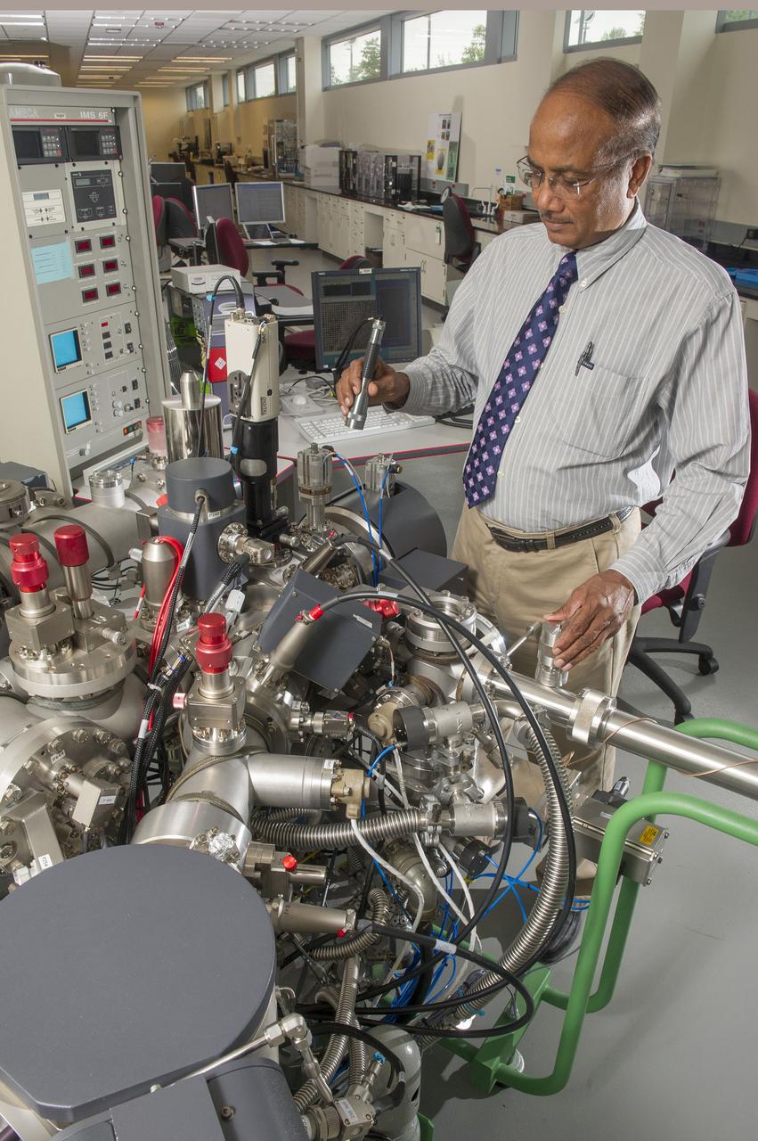 DR. BINAYAK PANDA LOADS A SAMPLE IN THE IMS-6F SECONDARY ION MASS SPECTROSCOPE’S ULTRA HIGH VACUUM CHAMBER.  IT IS CAPABLE OF ANALYZING VERY LIGHT ELEMENTS SUCH AS HYDROGEN AND LITHIUM IN ALLOYS. IT CAN ALSO ANALYZE VERY SMALL QUANTITIES OF IMPURITIES IN MATERIALS AT PARTS PER MILLION LEVELS, AND DETERMINE ISOTOPE RATIOS OF ELEMENTS, ALL IN SOLID SAMPLES.