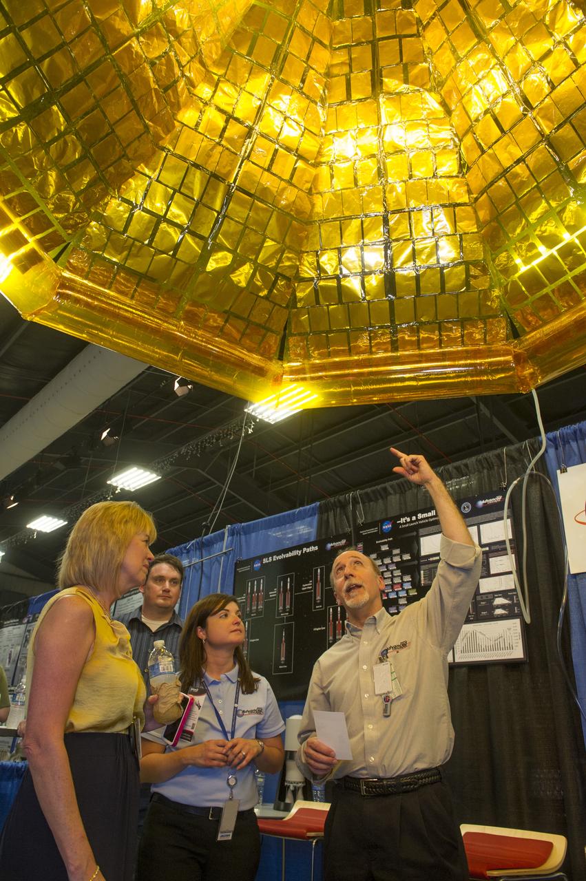 TERESA VANHOOSER, LEFT, DEPUTY DIRECTOR OF THE MARSHALL SPACE FLIGHT CENTER, LISTENS AS ADVANCED PLANNING ANALYST STEVE LAMBING, RIGHT, GOES INTO DETAIL ABOUT A PROPOSED INFLATABLE SOLAR ARRAY WITH, FROM LEFT, ANDREW SCHNELL WITH THE ADVANCED CONCEPTS OFFICE AND STEFANIE JUSTICE, A PROJECT ENGINEER WITH JACOBS ENGINEERING GROUP