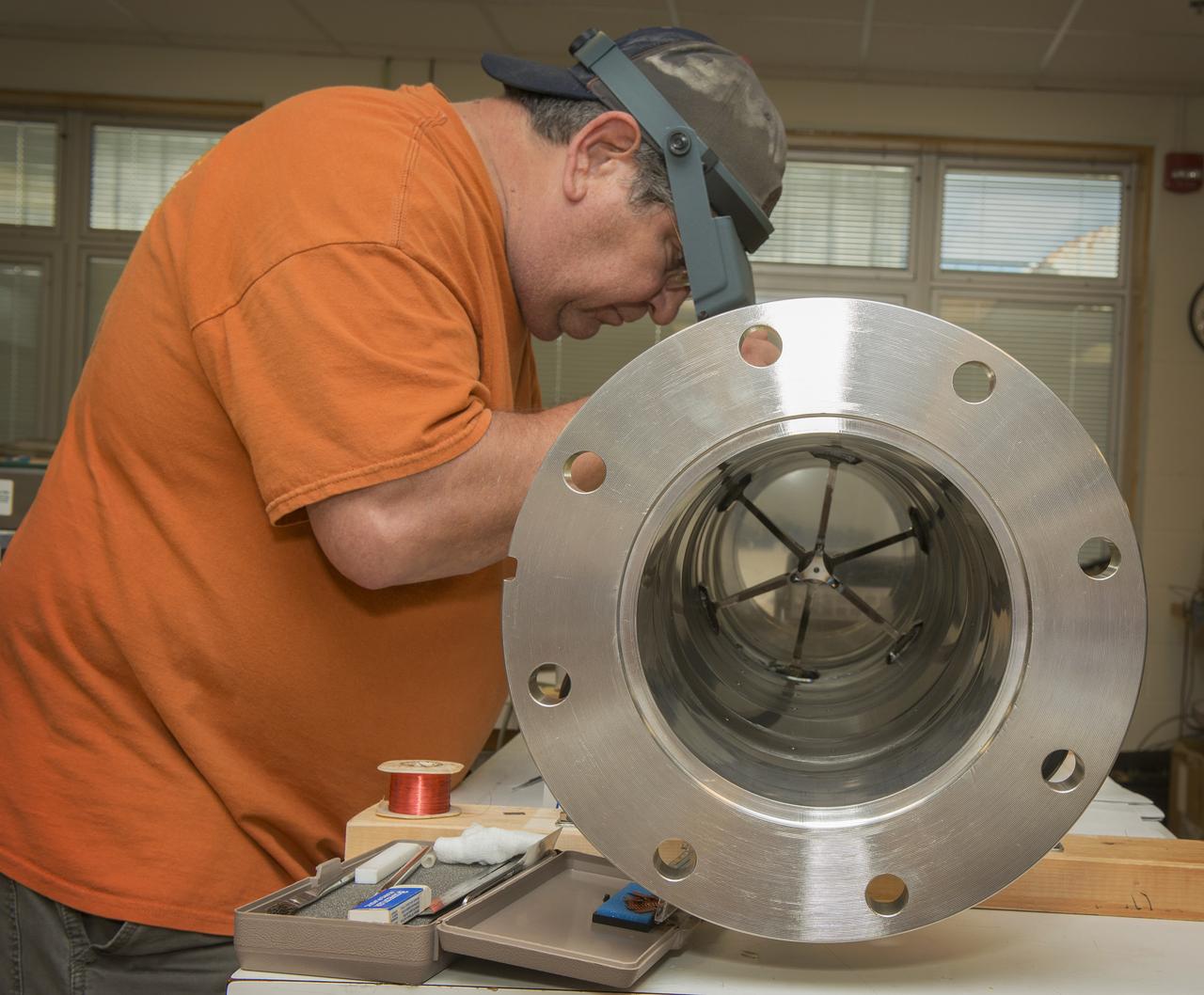 JOE MIRANDY, ET20, PREPARES SENSORS ON THE POGO Z- BAFFLE AND BELLOWS PRIOR TO FLOW TESTING. THE SENSORS WILL MEASURE VIBRATION AS FUEL FLOWS THROUGH THE TUBE AND BAFFLE.