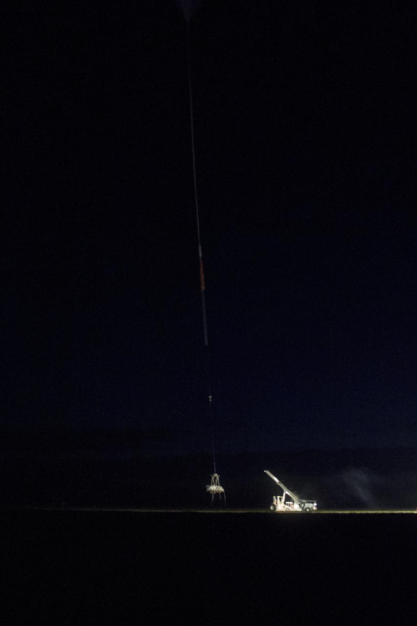HEROES PAYLOAD AWAITS LAUNCH AS HELIUM BALLOON INFLATES IN BACKGROUND, FORT SUMNER, NEW MEXICO, SEPTEMBER 21, 2013