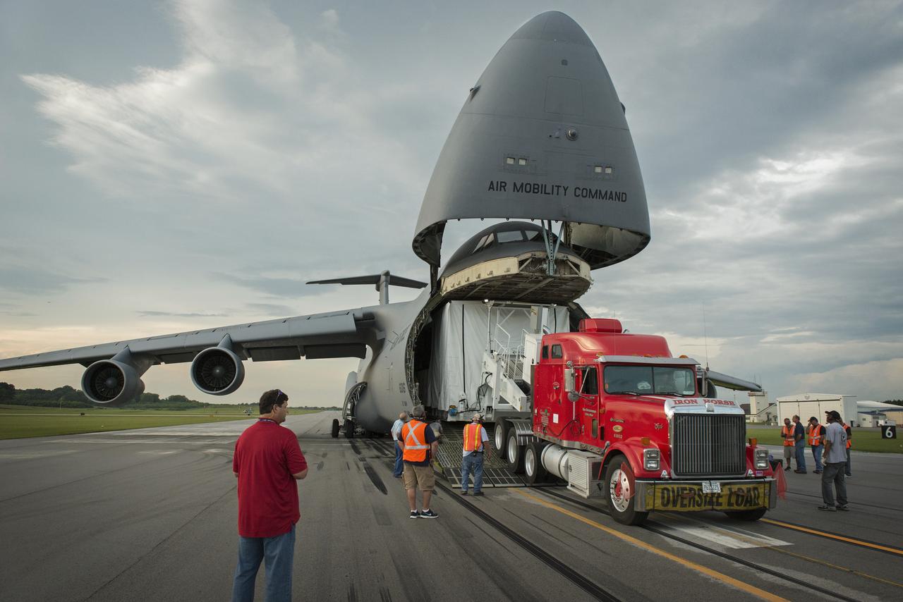 THE TRAILER CONTAINING THE JAMES WEBB SPACE TELESCOPE (JWST) BACKPLANE TEST ARTICLE IS UNLOADED FROM THE C5A AIRCRAFT AT REDSTONE AIRFIELD. THE TEST ARTICLE IS SCHEDULED TO UNDERGO TESTING AT THE X-RAY CALIBRATION FACILITY (XRCF) AT MSFC.
