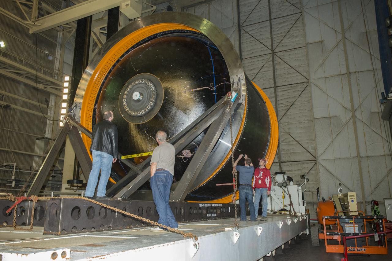 NASA AND BOEING ENGINEERS INSPECT AND PREPARE ONE OF THE LARGEST COMPSITE ROCKET PROPELLANT TANKS EVER MANUFACTURED. THE COMPOSITE CRYOTANK PROMISES A 30% WEIGHT REDUCTION AND A 25 % COST REDUCTION OVER THE PREVIOUSLY USED METAL TANKS.
