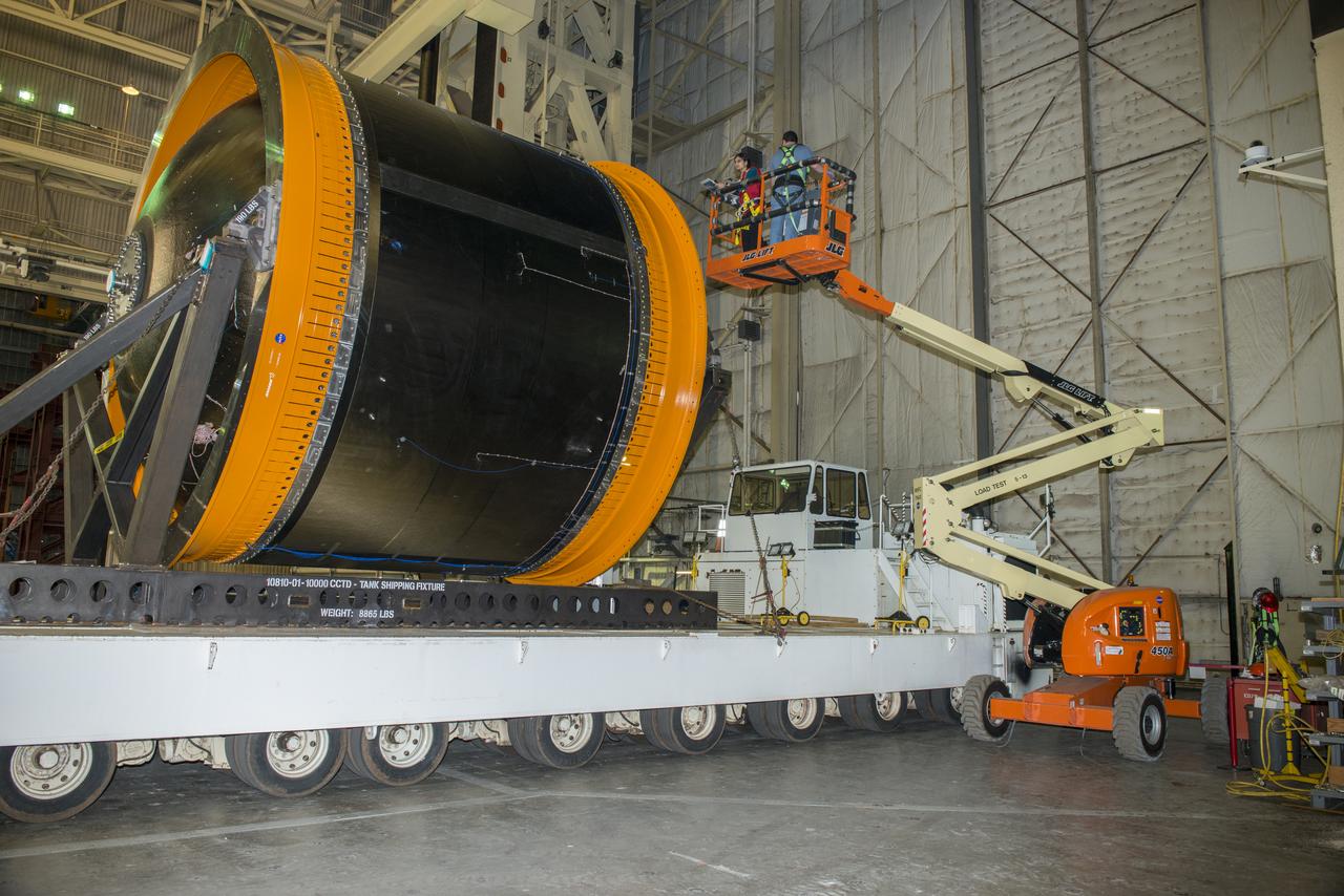 NASA AND BOEING ENGINEERS INSPECT AND PREPARE ONE OF THE LARGEST COMPSITE ROCKET PROPELLANT TANKS EVER MANUFACTURED. THE COMPOSITE CRYOTANK PROMISES A 30% WEIGHT REDUCTION AND A 25 % COST REDUCTION OVER THE PREVIOUSLY USED METAL TANKS.