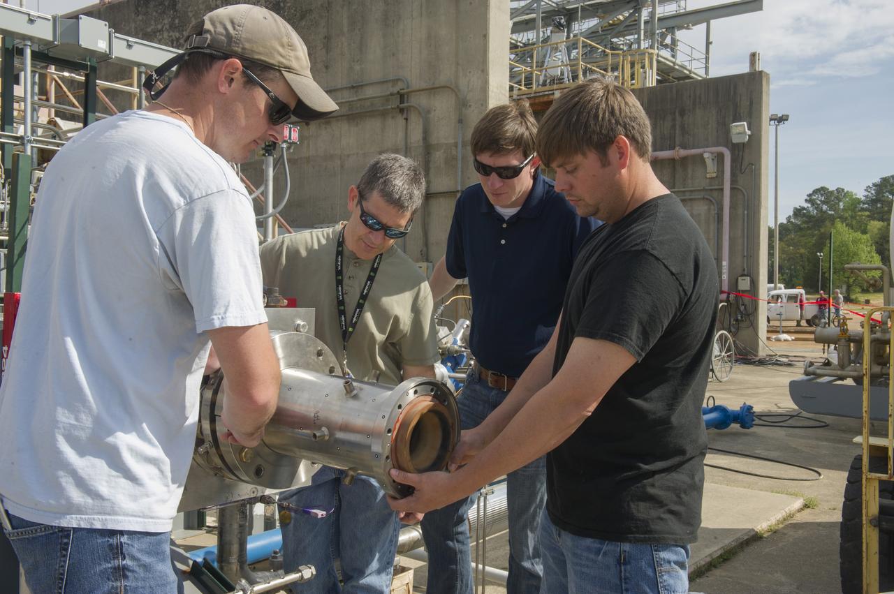 2. ENGINEERS AND TECHNICIANS PREPARE FOR AN UPCOMING HOT-FIRE TEST OF A ROCKET INJECTOR MANUFACTURED USING ADDITIVE MANUFACTURING, OR 3-D PRINTING…(L TO R)  WILLIE PARKER, INFOPRO TECHNICIAN, BRAD BULLARD, NASA, NICK CASE, NASA, AND RANDALL MCALLISTER, INFOPRO TECHNICIAN