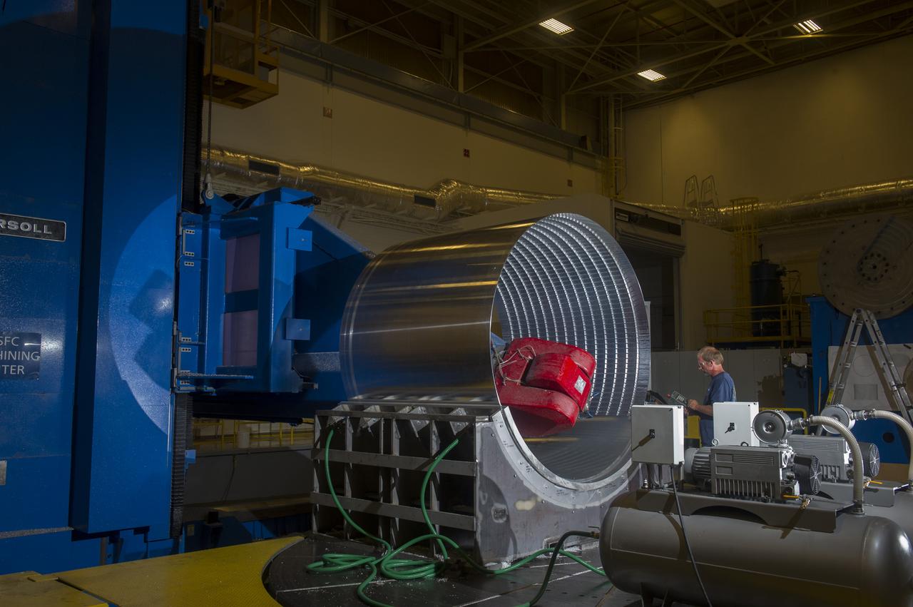 DAVID OSBORNE, A MACHINIST ON THE METTS CONTRACT, OPERATES THE 7-AXIS MILLING MACHINE WITH CF1 BARREL BEING PREPARED FOR SHELL BUCKLE TESTING