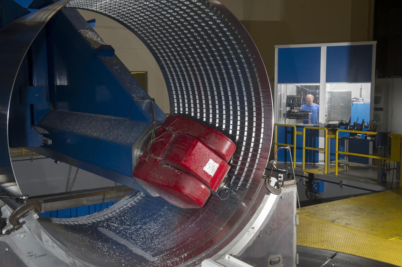 DAVID OSBORNE, A MACHINIST ON THE METTS CONTRACT, OPERATES THE 7-AXIS MILLING MACHINE WITH CF1 BARREL BEING PREPARED FOR SHELL BUCKLE TESTING