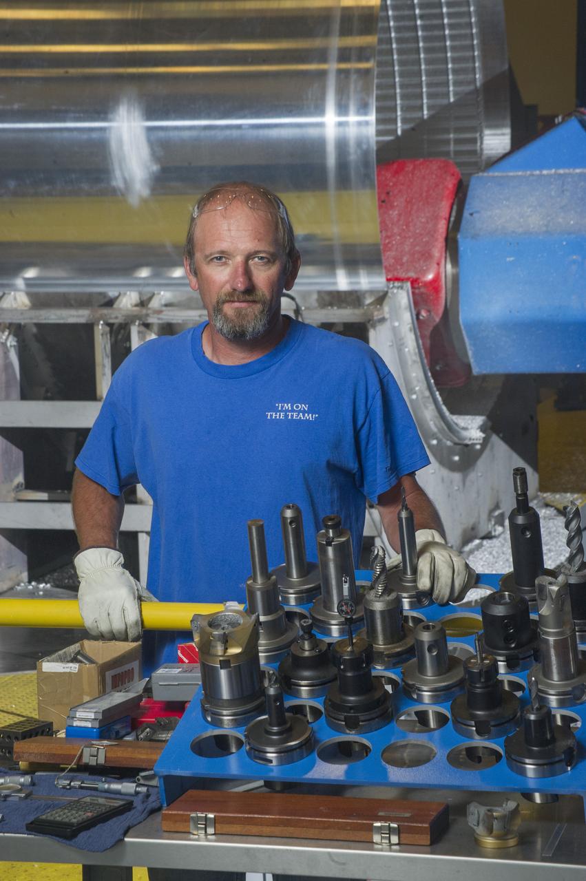 DAVID OSBORNE, A MACHINIST ON THE METTS CONTRACT, OPERATES THE 7-AXIS MILLING MACHINE WITH CF1 BARREL BEING PREPARED FOR SHELL BUCKLE TESTING