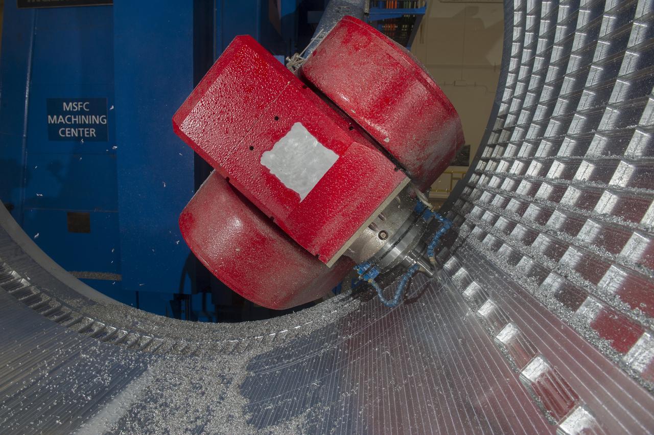 7-AXIS MILLING MACHINE CUTS ORTHOGRID TOOL PATH ON 8 FOOT CF1 BARREL IN SUPPORT OF SHELL BUCKLE TESTING