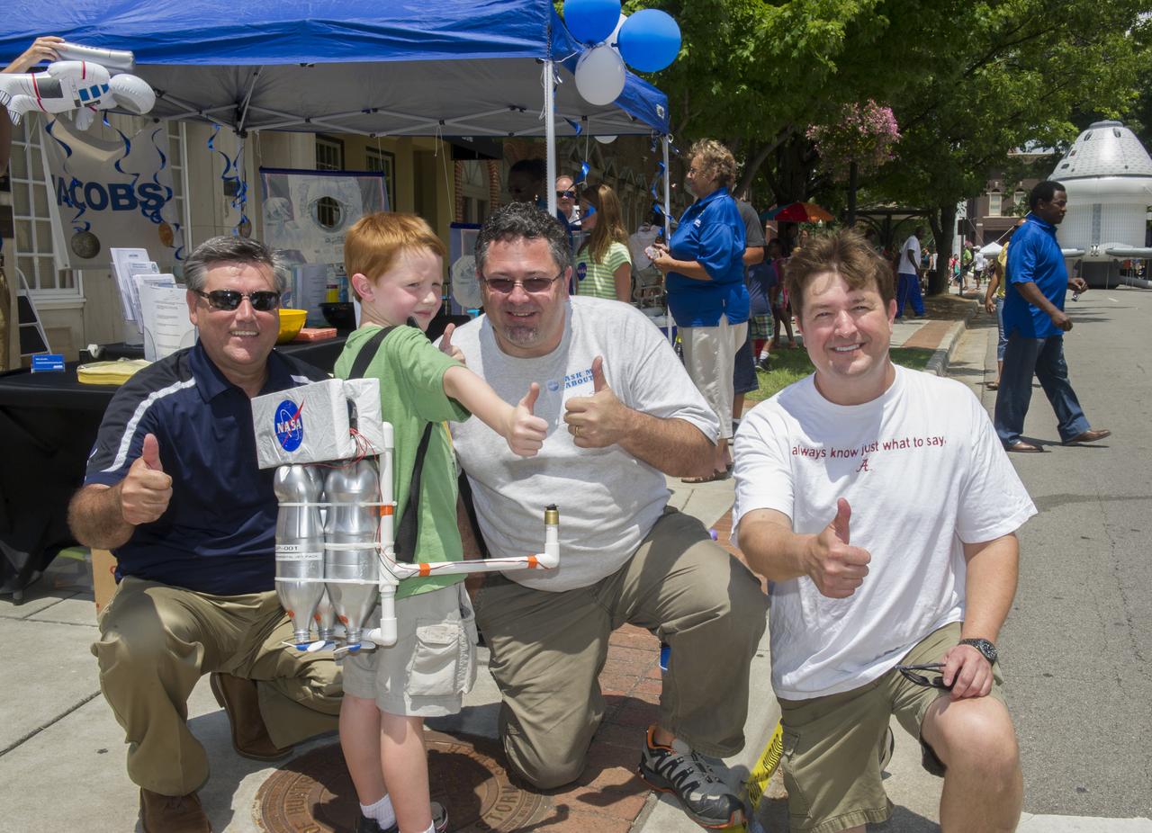 OWEN DEAN, A 6 YEAR OLD STUDENT AT CENTRAL ELEMENTARY SCHOOL PROUDLY DISPLAYS JETPACK AND GIVES “THUMBS UP” WITH PATRICK SCHEYERMANN, TODD MAY, AND MIKE KYNARD