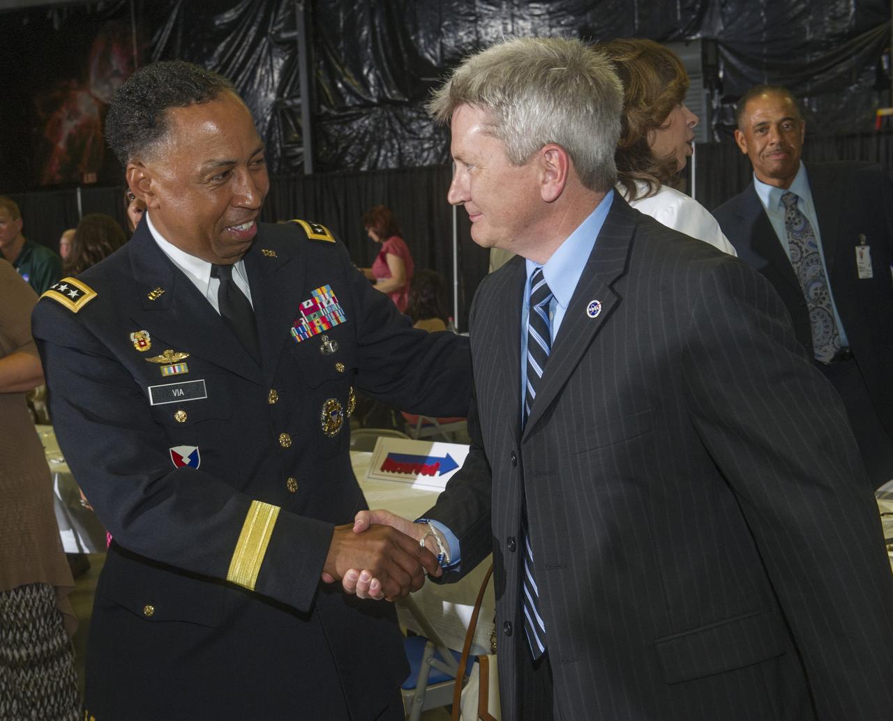 JOHNNY STEPHENSON, RIGHT, DEPUTY DIRECTOR OF THE MARSHALL SPACE FLIGHT CENTER'S OFFICE OF STRATEGIC ANALYSIS & COMMUNICATIONS, GREETS GENERAL DENNIS VIA, COMMANDER OF THE U.S. ARMY MATERIEL COMMAND (AMC) ON REDSTONE ARSENAL. VIA, WHO OVERSEES A WORK FORCE OF MORE THAN 67,000 DEDICATED MILITARY AND CIVILIAN EMPLOYEES, WAS THE GUEST SPEAKER AT THE JULY 10 LUNCHEON MEETING OF THE MARSHALL ASSOCIATION, THE CENTER'S PROFESSIONAL, EMPLOYEE SERVICE ORGANIZATION.