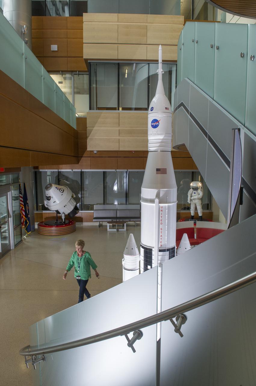 THE INTERIOR OF THE MARSHALL SPACE FLIGHT CENTER’S NEWLY OPENED BUILDING 4220, PRIMARILY HOME TO THE SPACE LAUNCH SYSTEM PROGRAM, REFLECTS A BLEND OF AESTHETICS, PRACTICALITY AND HIGH EFFICIENCY. THE COST-CONSCIOUS NEW FACILITY IS ENVIRONMENTALLY FRIENDLY ON ALL FRONTS, FEATURING STATE-OF-THE-ART GREEN TECHNOLOGIES AND ENERGY-CONSERVATION SYSTEMS THROUGHOUT THE BUILDING. THE ENTIRE STRUCTURE IS SPECIALLY INSULATED, WITH MUCH OF THE EXTERIOR COVERED IN LOW-EMISSIVITY GLASS THAT DEFLECTS HEAT TO REDUCE COOLING COSTS WITHIN. ROOFTOP SOLAR-POWER UNITS ABSORB ENERGY TO AUGMENT ELECTRICAL POWER, AND A 10,000-GALLON CISTERN COLLECTS STORMWATER TO IRRIGATE THE SURROUNDING GREENERY. EVEN THE FACILITY'S NEW PARKING LOT HAS A GREEN ELEMENT: RATHER THAN GUTTERS, IT INCLUDES A "BIOSWALE," A NATURAL, SOIL-AND-VEGETATION-BASED MEANS OF CAPTURING AND FILTERING STORMWATER RUNOFF, WHICH IS DIRECTED INTO A NEARBY COLLECTING POND. ONCE CERTIFICATION IS COMPLETE, BUILDING 4220 WILL BECOME THE SEVENTH LEED CERTIFIED MARSHALL STRUCTURE ON CAMPUS