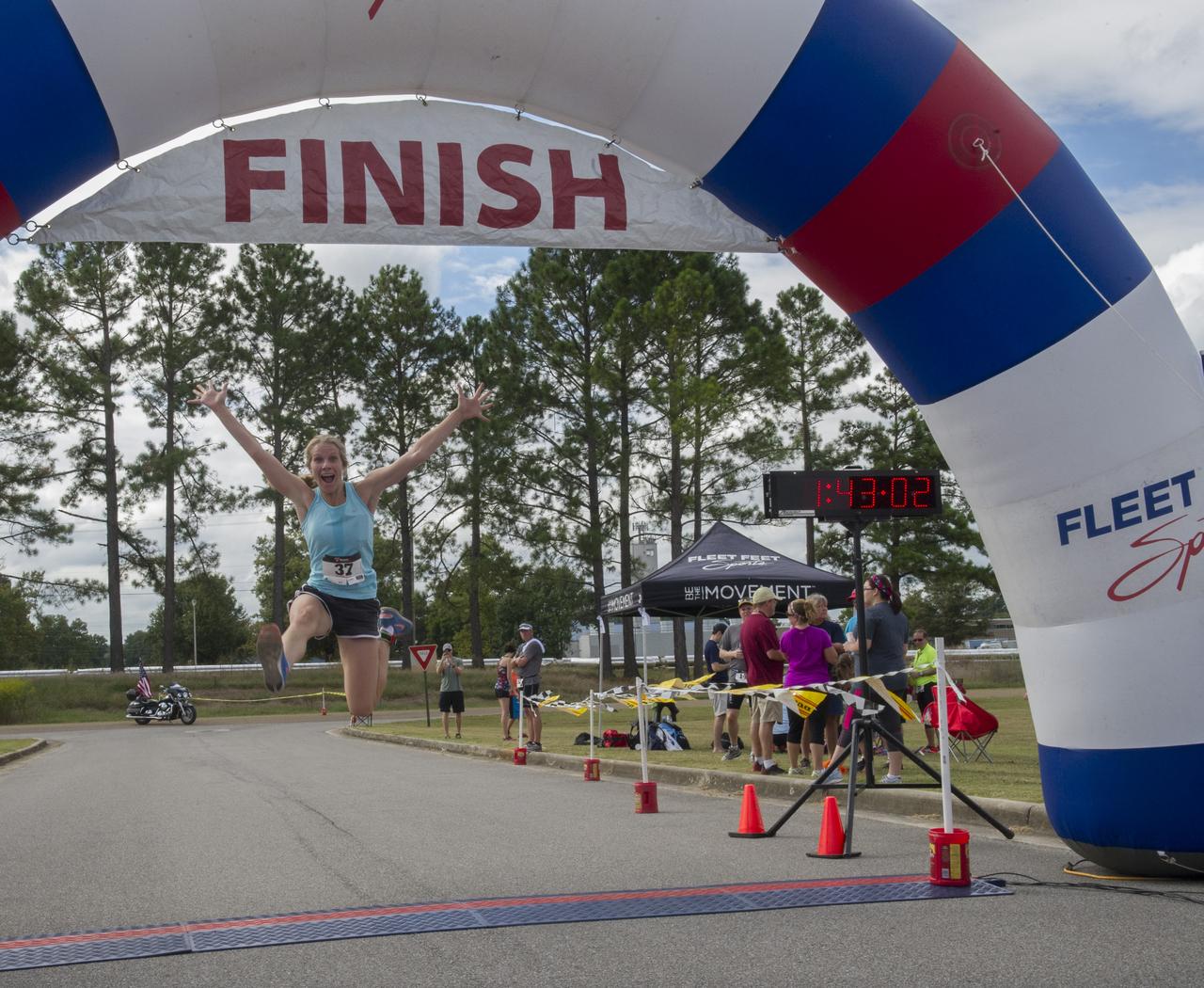HUNTSVILLE RESIDENT JESSICA WYSOCK, AN EMERGENCY ROOM NURSE AT CRESTWOOD HOSPITAL, SHOWED HER EXUBERANCE WHILE LEAPING ACROSS THE FINISH LINE AT THE ANNUAL RACIN' THE STATION DUATHLON SEPT. 27