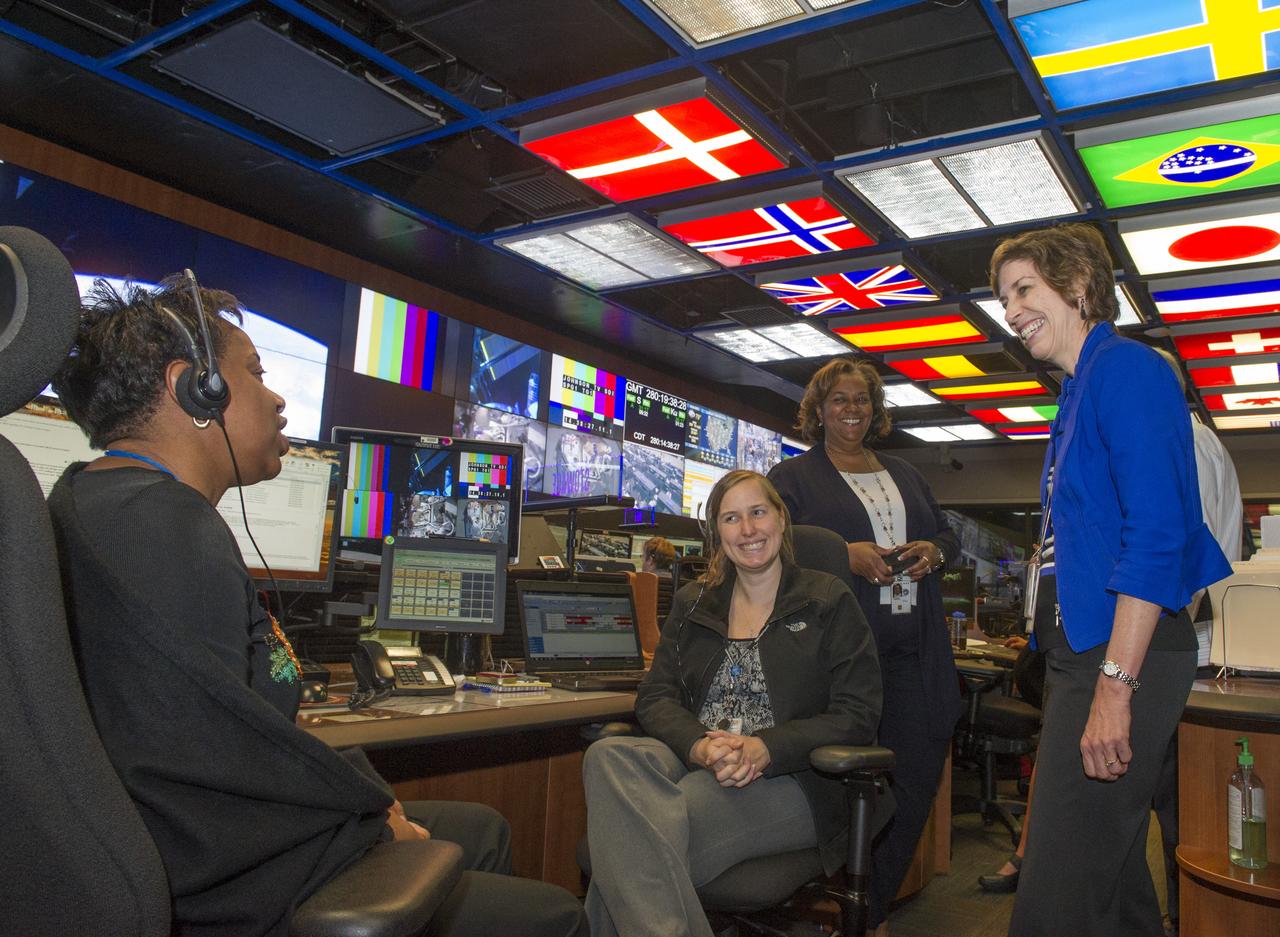 FROM LEFT, EUGENA GOGGANS AND MELISSA HOPPER, BOTH STOWAGE ENGINEERS, AND LYBREASE WOODARD, ASSOCIATE DIRECTOR OF THE MISSION OPERATIONS LAB, GREET DR. ELLEN OCHOA IN THE PAYLOAD OPERATIONS INTEGRATION CENTER FOR THE ISS