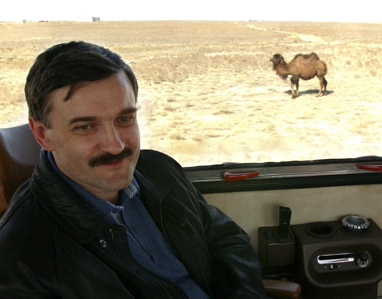 Cosmonaut Alexander Kaleri, backup crew member for Expedition 7, enjoys the bus ride to the Cosmonuat hotel after arriving in Baikonur, Kazakhstan on Wednesday, April 9, 2003. The crews performed fit checks on their Russian Sokol suits and performed a Soyuz inspection at the Baikonur Cosmodrome. Photo Credit: (NASA/Bill Ingalls)