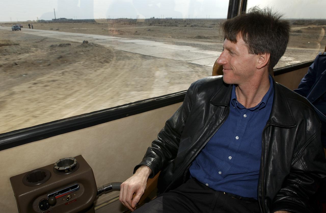 Astronaut Michael Foale, backup crew member for Expedition 7, looks out the bus window during the drive to the Cosmonaut Hotel in Baikonur, Kazakhstan on Wednesday, April 9, 2003. The crews performed fit checks on their Russian Sokol suits and performed a Soyuz inspection at the Baikonur Cosmodrome. Photo Credit: (NASA/Bill Ingalls)