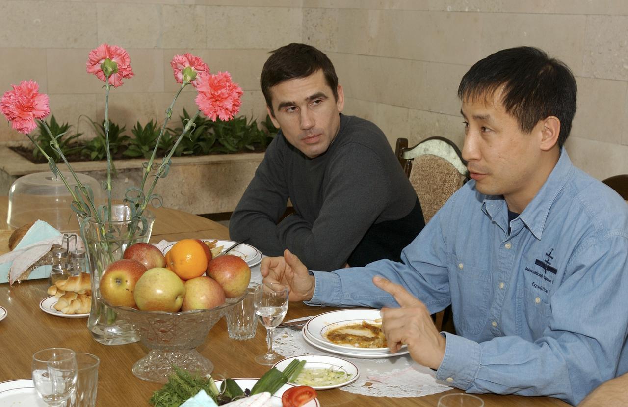 Expedition 7 commander Yuri I. Malenchenko, left, and NASA International Space Station Science Officer and Flight Engineer Edward T. Lu enjoy dinner at the Cosmonaut Hotel in Baikonur, Kazakhstan, Wednesday, April 9, 2003. Photo Credit: (NASA/Bill Ingalls)