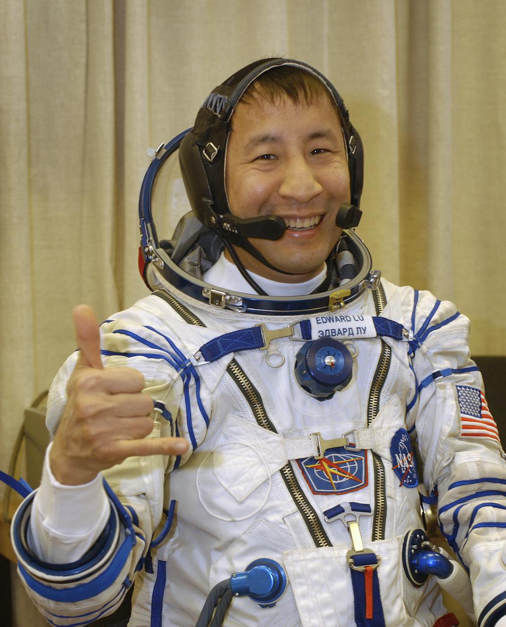 Astronaut Edward T. Lu, NASA International Space Station Science Officer and Flight Engineer for Expedition 7, dons his Russian Sokol suit for the leak check, seat liner check and Soyuz inspection at the Soyuz Integration Facility at the Baikonur Cosmodrome in Baikonur, Kazakhstan, Thursday, April 10, 2003. Photo Credit: (NASA/Bill Ingalls)
