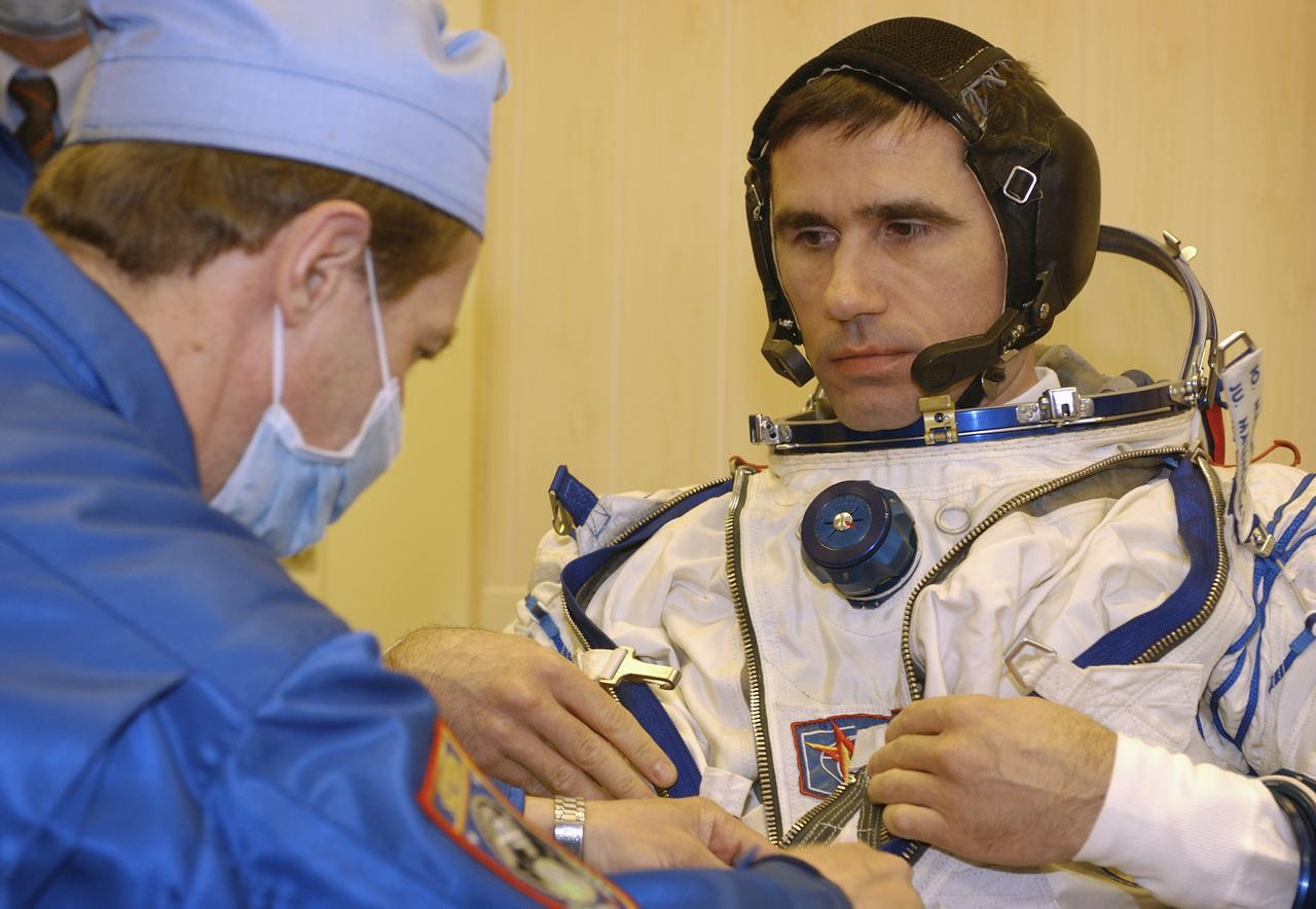 Expedition 7 Commander Yuri I. Malenchenko dons his Russian Sokol suit for the leak check, seat liner check and Soyuz inspection at the Soyuz Integration Facility at the Baikonur Cosmodrome in Baikonur, Kazakhstan, Thursday, April 10, 2003. Photo Credit: (NASA/Bill Ingalls)