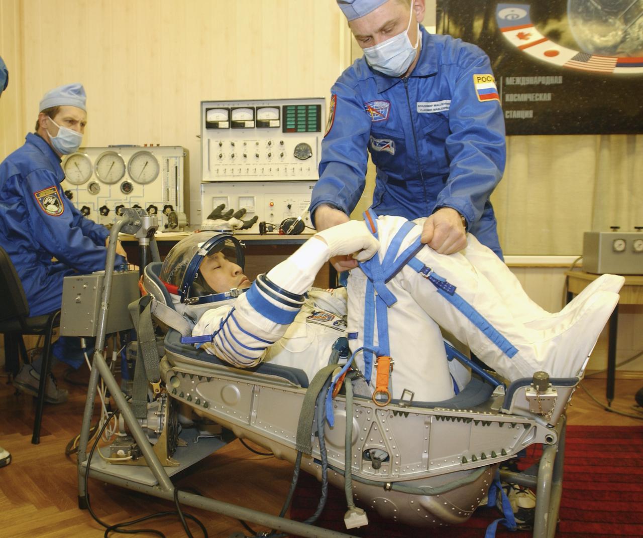 Astronaut Edward T. Lu, Expedition 7 NASA International Space Station Science Officer and Flight Engineer, has a leak check performed on his Russian Sokol suit in the Soyuz Integration Facility at the Baikonur Cosmodrome in Baikonur, Kazakhstan, Thursday, April 10, 2003. Photo Credit: (NASA/Bill Ingalls)