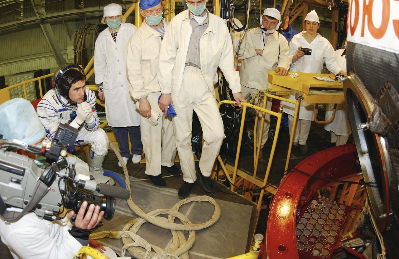 Expedition 7 Commander Yuri I. Malenchenko waits for his turn to enter the Soyuz TMA-2 capsule for inspection and seat liner check in the Soyuz Integration Facility at the Baikonur Cosmodrome, in Baikonur, Kazakhstan, Thursday, April 10, 2003. Photo Credit: (NASA/Bill Ingalls)