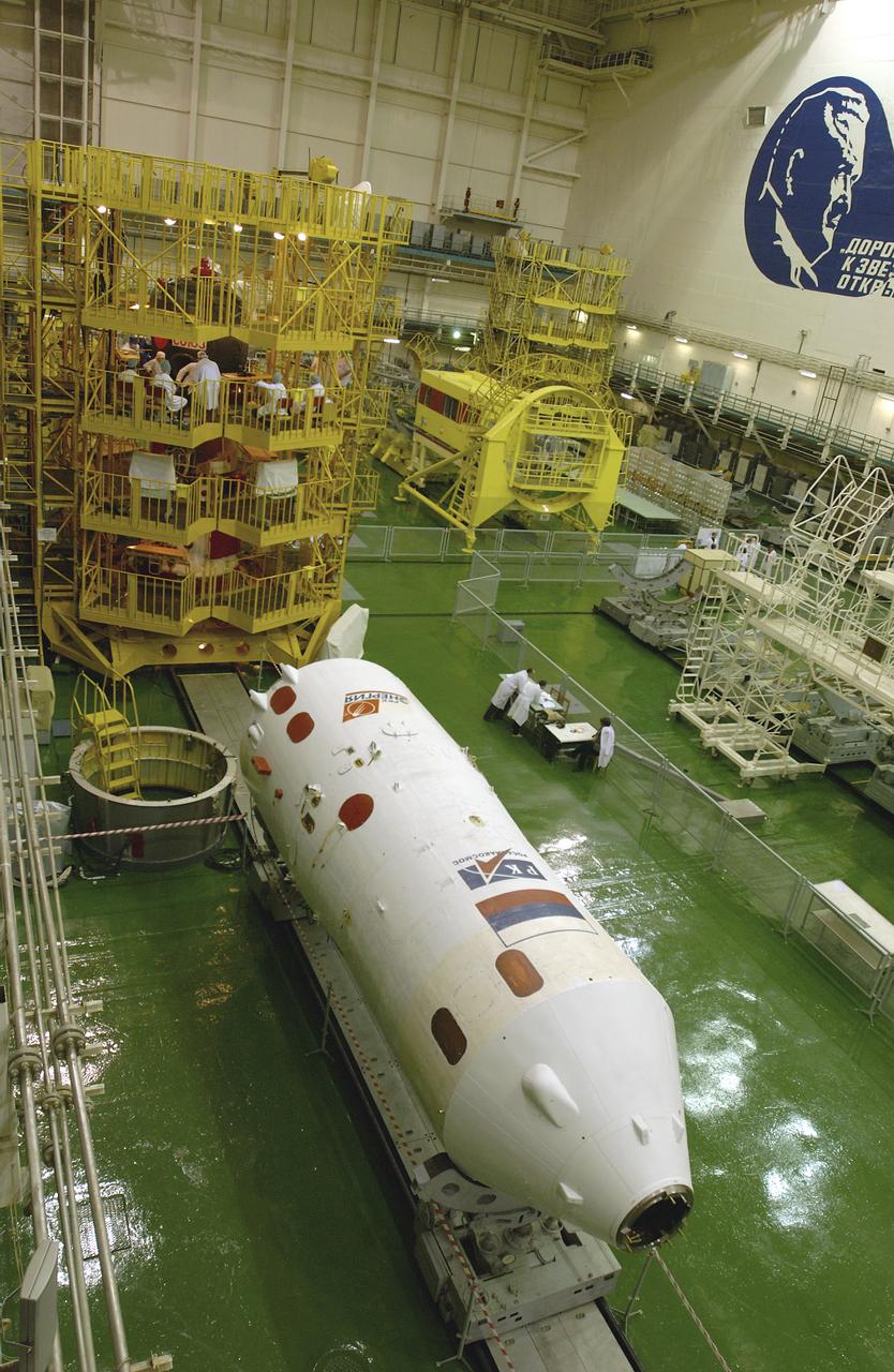 The interior of the Soyuz Integration Facility at the Baikonur Cosmodrome in Baikonur, Kazakhstan is seen, Thursday, April 10, 2003. The Soyuz module is in the yellow work stand with its payload fairing ready in the foreground. Expedition 7 NASA International Space Station Science Officer and Flight Engineer Edward T. Lu and Expedition 7 Commander Yuri I. Malenchenko (both out of view) are in the Soyuz TMA-2 capsule for an inspection and seat liner check.