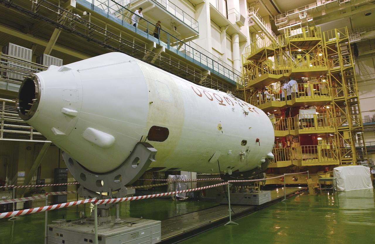 The interior of the Soyuz Integration Facility at the Baikonur Cosmodrome in Baikonur, Kazakhstan is seen, Thursday, April 10, 2003. The Soyuz module is in the yellow work stand with its payload fairing ready in the foreground. Expedition 7 NASA International Space Station Science Officer and Flight Engineer Edward T. Lu and Expedition 7 Commander Yuri I. Malenchenko (both out of view) are in the Soyuz TMA-2 capsule for an inspection and seat liner check.