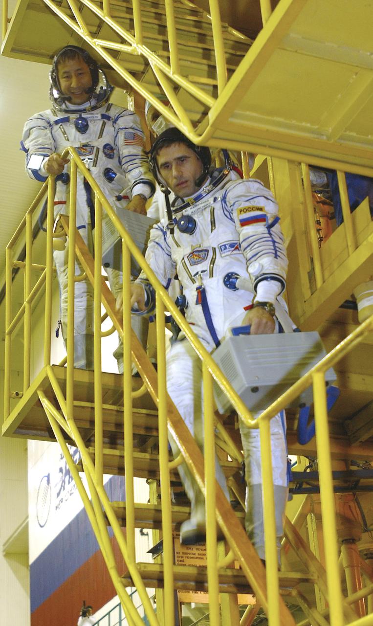 Cosmonaut Yuri I. Malenchenko, Expedition 7 commander, foreground and astronaut Edward T. Lu, NASA International Space Station science officer and flight engineer for Expedition 7, walk down the Soyuz stand after the Soyuz inspection and seat liner check at the Baikonur Cosmodrome, Building 254, Soyuz Integration Facility in Kazakhstan, Thursday, April 10, 2003. Photo Credit: (NASA/Bill Ingalls)