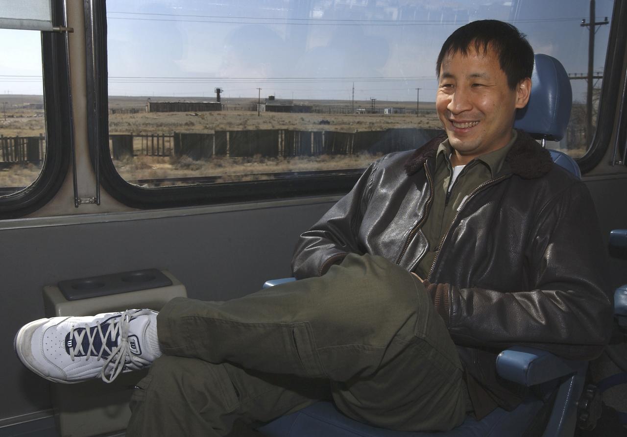 Astronaut Edward T. Lu, NASA International Space Station science officer and flight engineer for Expedition 7, enjoys the long bus ride back to the cosmonaut hotel after a busy day at the Baikonur Cosmodrome, Building 254, Soyuz Integration Facility in Kazakhstan, Thursday, April 10, 2003. Photo Credit: (NASA/Bill Ingalls)