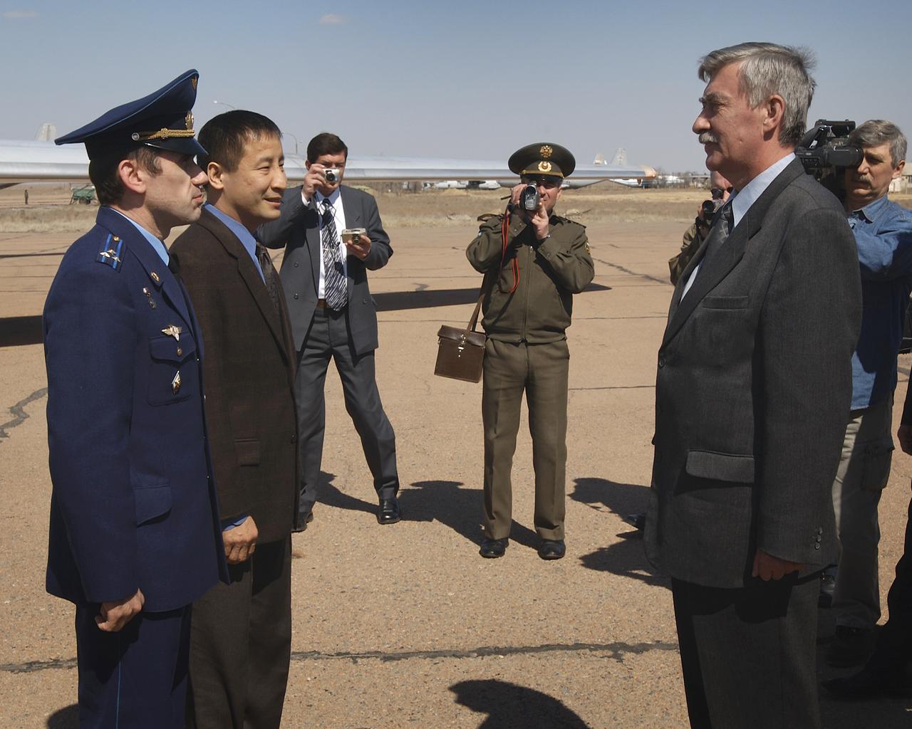 Cosmodrome officials greet Yuri I. Malenchenko, Expedition 7 Commander, left and Edward T. Lu, NASA International Space Station Science Officer and Flight Engineer, second from left, upon arriving in Baikonur, Kazakhstan, Sunday, April 20, 2003, The expedition crew will be preparing for the launch onboard a Soyuz capsule, Saturday, April 26, 2003. Photo Credit: (NASA/Bill Ingalls)