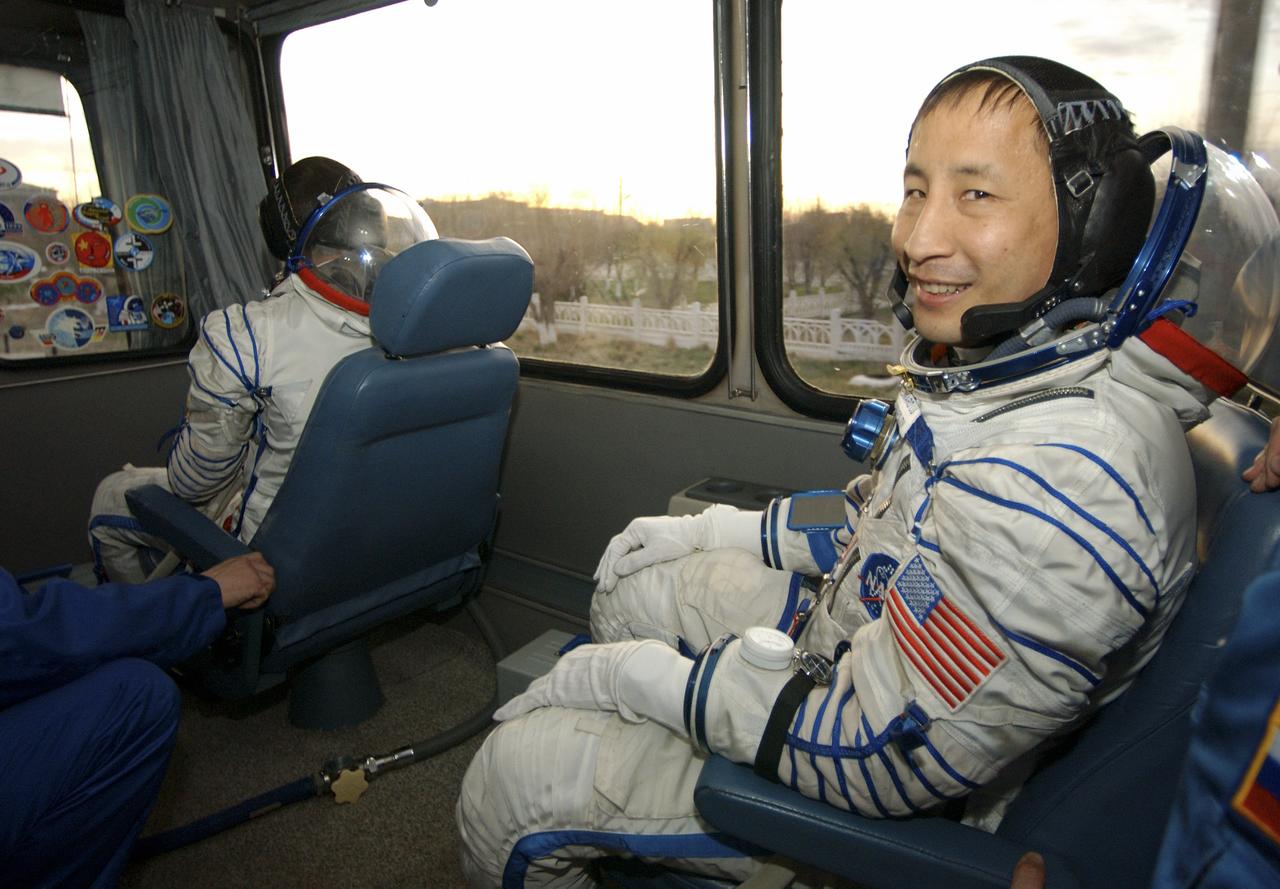 Edward T. Lu, right, Expedition 7 NASA International Space Station Science Officer and Flight Engineer, and Yuri I. Malenchenko, Mission Commander, ride in a bus to the launch pad prior to their launch onboard the Soyuz rocket at the Baikonur Cosmodrome in Baikonur, Kazakhstan, Saturday, April 26, 2003. Photo credit: (NASA/Bill Ingalls)