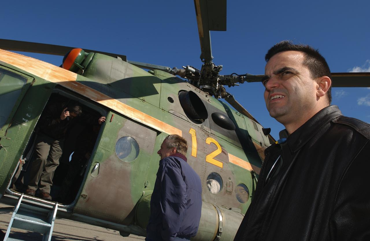 Director of Flight Crew Operations Bob Cabana, upper left, talks with NASA colleagues on the satellite phone from a Russian helicopter while International Space Station Program Manager, William Gerstenmaier and J.D. Polk, Expedition 6 Flight Surgeon, right, wait to get word if they will be continuing on to the landing site after a refueling stop, Tuesday, May 4, 2003 in Kazakhstan.  Photo Credit: (NASA/Bill Ingalls)