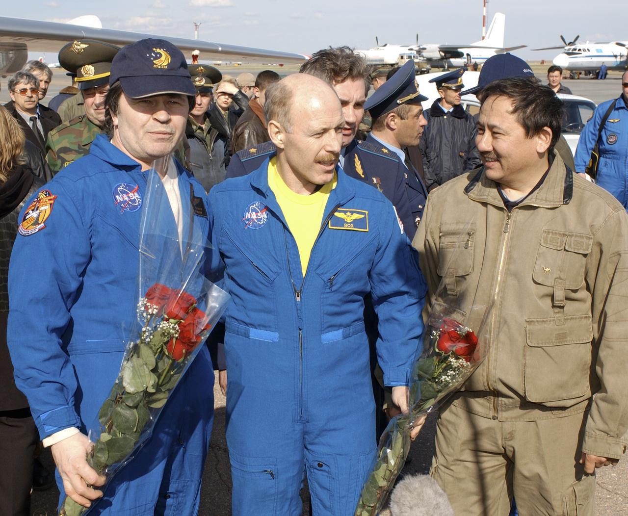 Expedition 6 Flight Engineer Nikolai Budarin, left, and Commander Ken Bowersox are greeted by Cosmonaut Talgat Musabayev, right, on Tuesday, May 4, 2003, after their arrival in Astana, Kazakhstan. The Expedition 6 Soyuz capsule landed in Kazakhstan. Photo Credit: (NASA/Bill Ingalls)