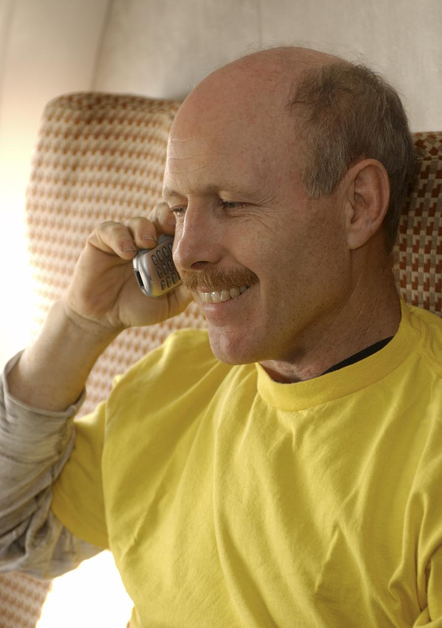 Expedition 6 Commander Ken Bowersox calls his wife Annie from the airplane prior to departure from Astana, Kazakhstan to Moscow, Tuesday, May 4, 2003.  Photo Credit: (NASA/Bill Ingalls)