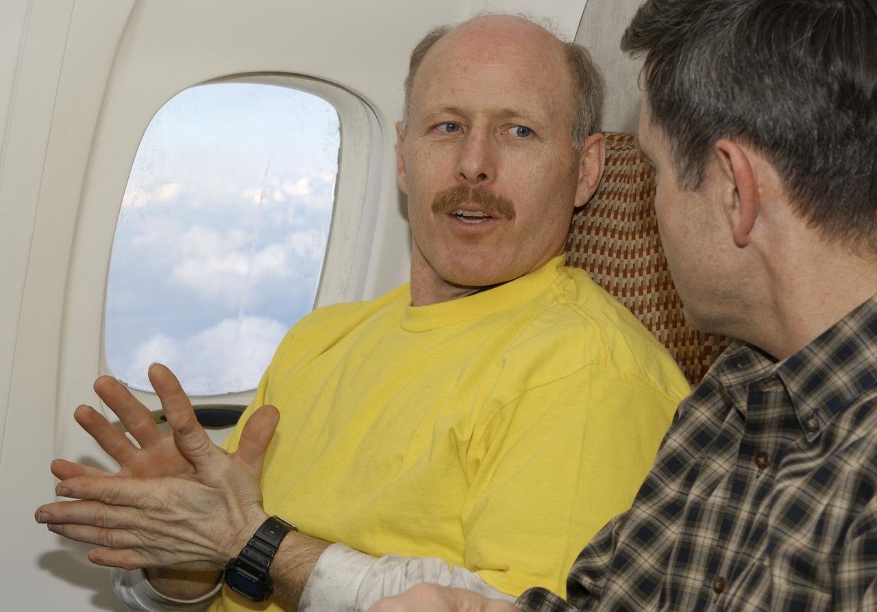 Expedition 6 Commander Ken Bowersox, left, talks about his mission with Bob Cabana, Director of Flight Crew Operations while on the airplane flying from Astana, Kazakhstan to Moscow on Tuesday, May 4, 2003.  Photo Credit: (NASA/Bill Ingalls)
