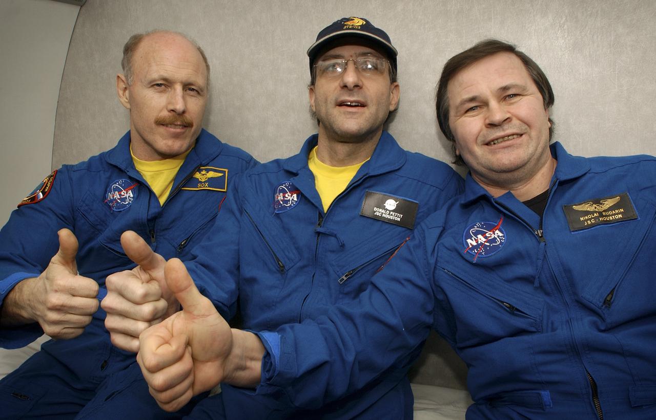 Expedition 6 Commander Ken Bowersox, left, NASA International Space Station Science Officer Don Pettit and Flight Engineer Nikolai Budarin, right, celebrate their mission onboard an aircraft flight from Kazakhstan to Moscow on Tuesday, May 4, 2003.  Photo Credit: (NASA/Bill Ingalls)