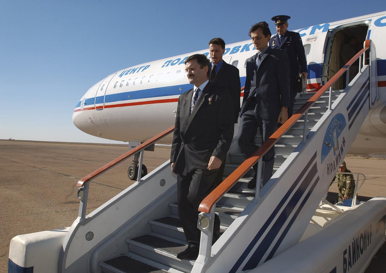 Expedition 8 Soyuz Commander and Flight Engineer Alexander Kaleri, left, Expedition 8 Commander Michael Foale, European Space Agency astronaut Pedro Duque of Spain, right, along with Valery Korzun, Chief of Cosmonauts, rear, arrive in Baikonur, Kazakhstan, Sunday, Oct. 12, 2003. Photo Credit (NASA/Bill Ingalls)