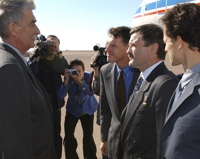 Victor Grin, a member of the Russian State Commission, left, greets Expedition 8 Commander Michael Foale, far right, Expedition 8 Soyuz Commander and Flight Engineer Alexander Kaleri and European Space Agency astronaut Pedro Duque of Spain, right, Sunday, Oct. 12, 2003, upon their arrival in Baikonur, Kazakhstan for the Oct. 18 launch of a Soyuz rocket to the International Space Station. Photo Credit (NASA/Bill Ingalls)