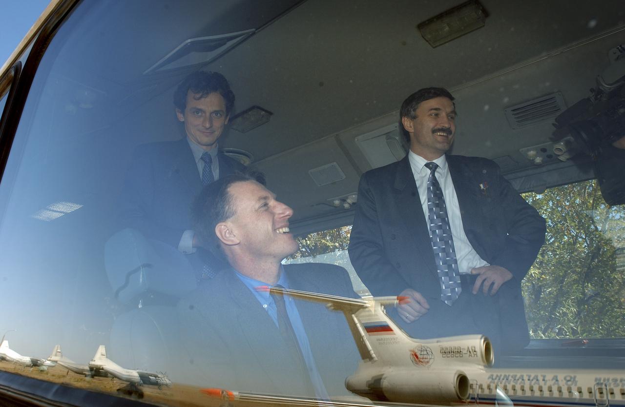 European Space Agency astronaut Pedro Duque of Spain, left, Expedition 8 Commander Michael Foale and Expedition 8 Soyuz Commander and Flight Engineer Alexander Kaleri gather on a bus following their arrival in Baikonur, Kazakhstan, Sunday, Oct. 12, 2003, in preparation for their Oct. 18 launch from the Baikonur Cosmodrome onboard a Soyuz rocket to the International Space Station. Photo Credit (NASA/Bill Ingalls)