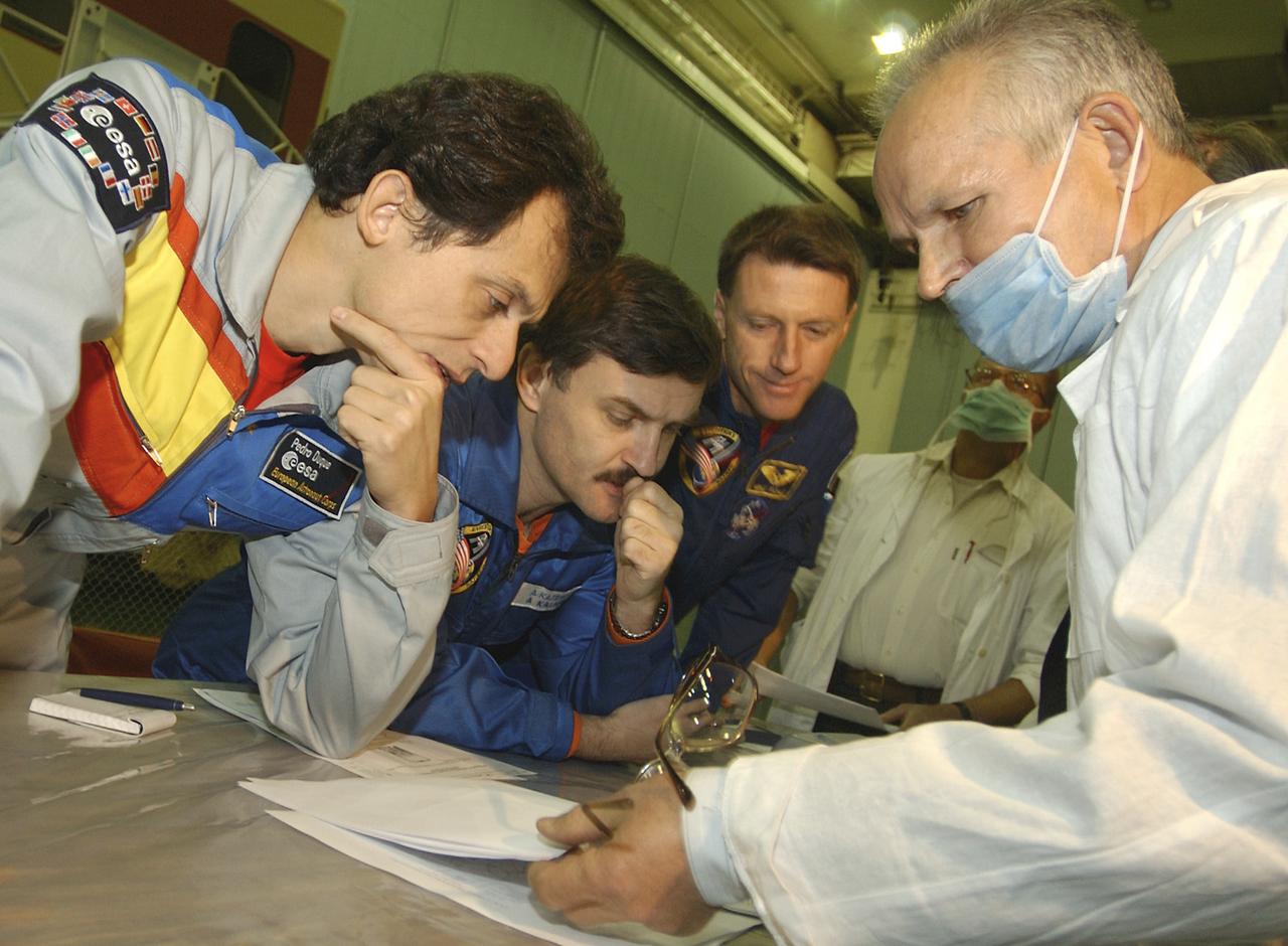 Expedition 8 Soyuz Commander and Flight Engineer Alexander Kaleri, center, Expedition 8 Commander Michael Foale, European Space Agency astronaut Pedro Duque of Spain, right, along with Valery Korzun, Chief of Cosmonauts, arrive in Baikonur, Kazakhstan, Sunday, Oct. 12, 2003. Photo Credit (NASA/Bill Ingalls)