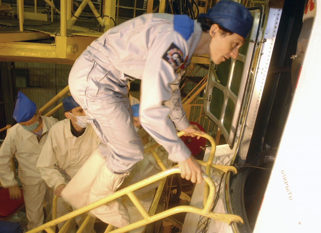 European Space Agency astronaut Pedro Duque of Spain climbs into the Soyuz TMA-3 vehicle in a processing facility at the Baikonur Cosmodrome in Kazakhstan on Monday, Oct. 13, 2003, during prelaunch training with his crew mates, Expedition 8 Commander and NASA Science Officer Mike Foale and Expedition 8 soyuz Commander Alexander Kaleri. The trio launched on Oct. 18, 2003 to the International Space Station. Photo Credit (NASA/Bill Ingalls)