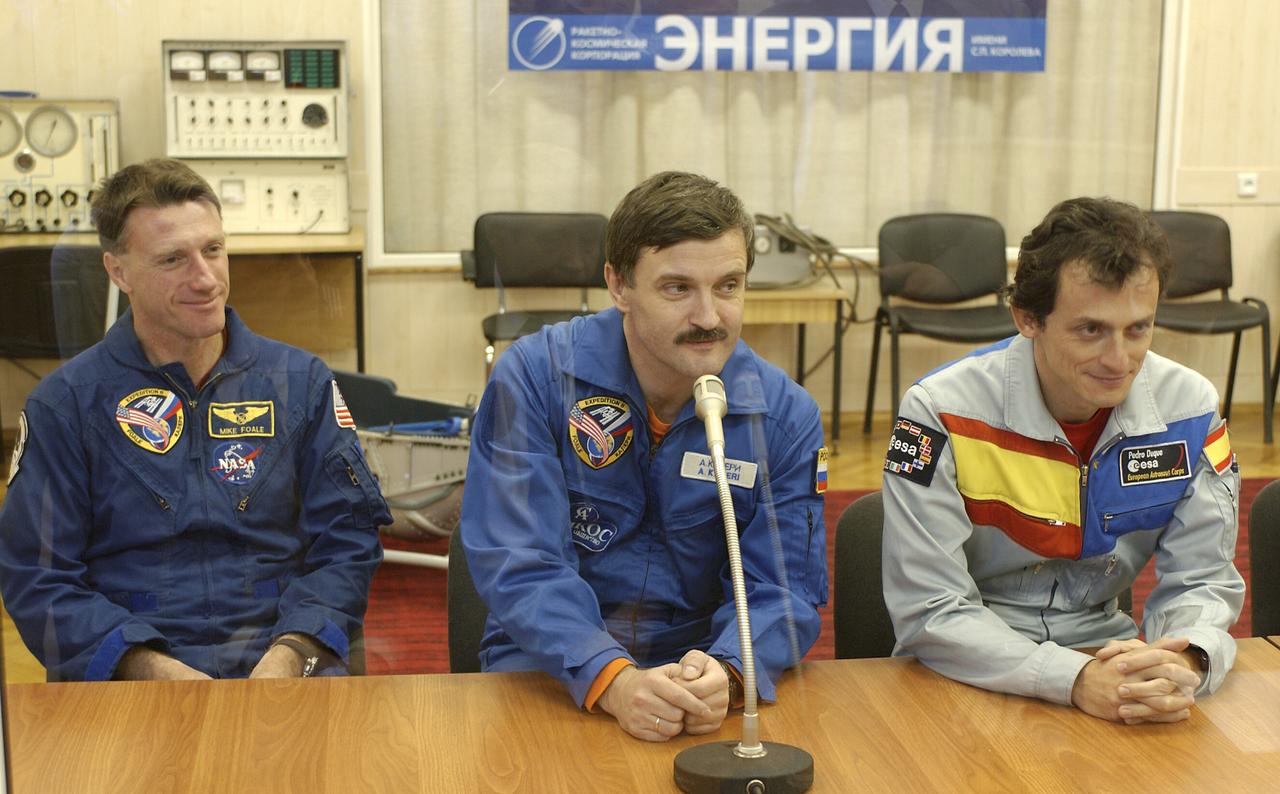 Expedition 8 Commander and NASA Science Officer Michael Foale, left, Expedition 8 Soyuz Commander Alexander Kaleri and European Space Agency Astronaut Pedro Duque of Spain, right, report to launch officials on their inspection of the Soyuz TMA-3 spacecraft during a final vehicle training session at the Baikonur Cosmodrome in Kazakhstan, Monday, Oct. 13, 2003. The trio launched to the International Space Station on Oct. 18, 2003. Photo Credit (NASA/Bill Ingalls)