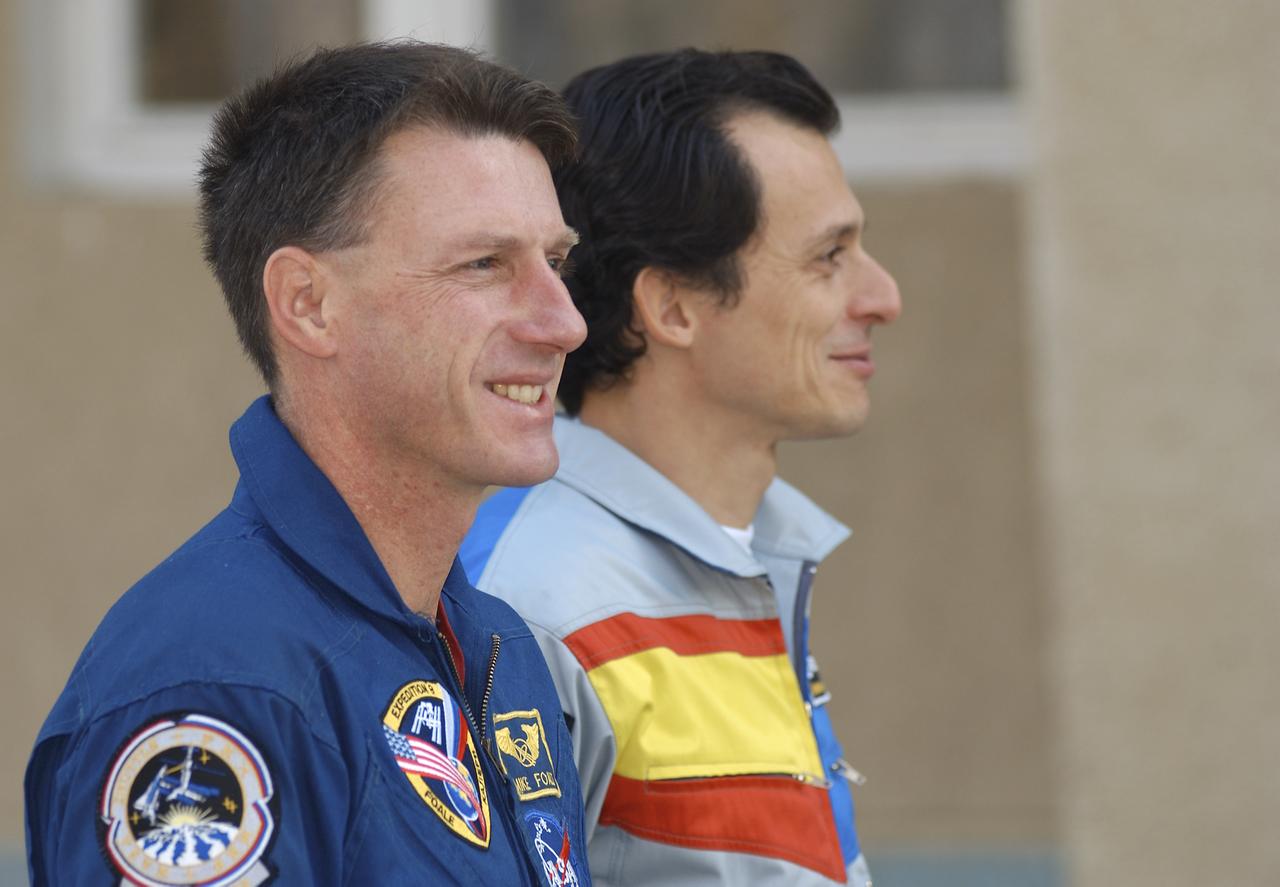 Expedition 8 Commander and NASA Science Officer Michael Foale, left, and European Space Agency astronaut Pedro Duque of Spain participate in the traditional raising of the flags at the Cosmonaut Hotel, Tuesday, Oct. 14, 2003, in Baikonur, Kazakhstan. Photo Credit (NASA/Bill Ingalls)