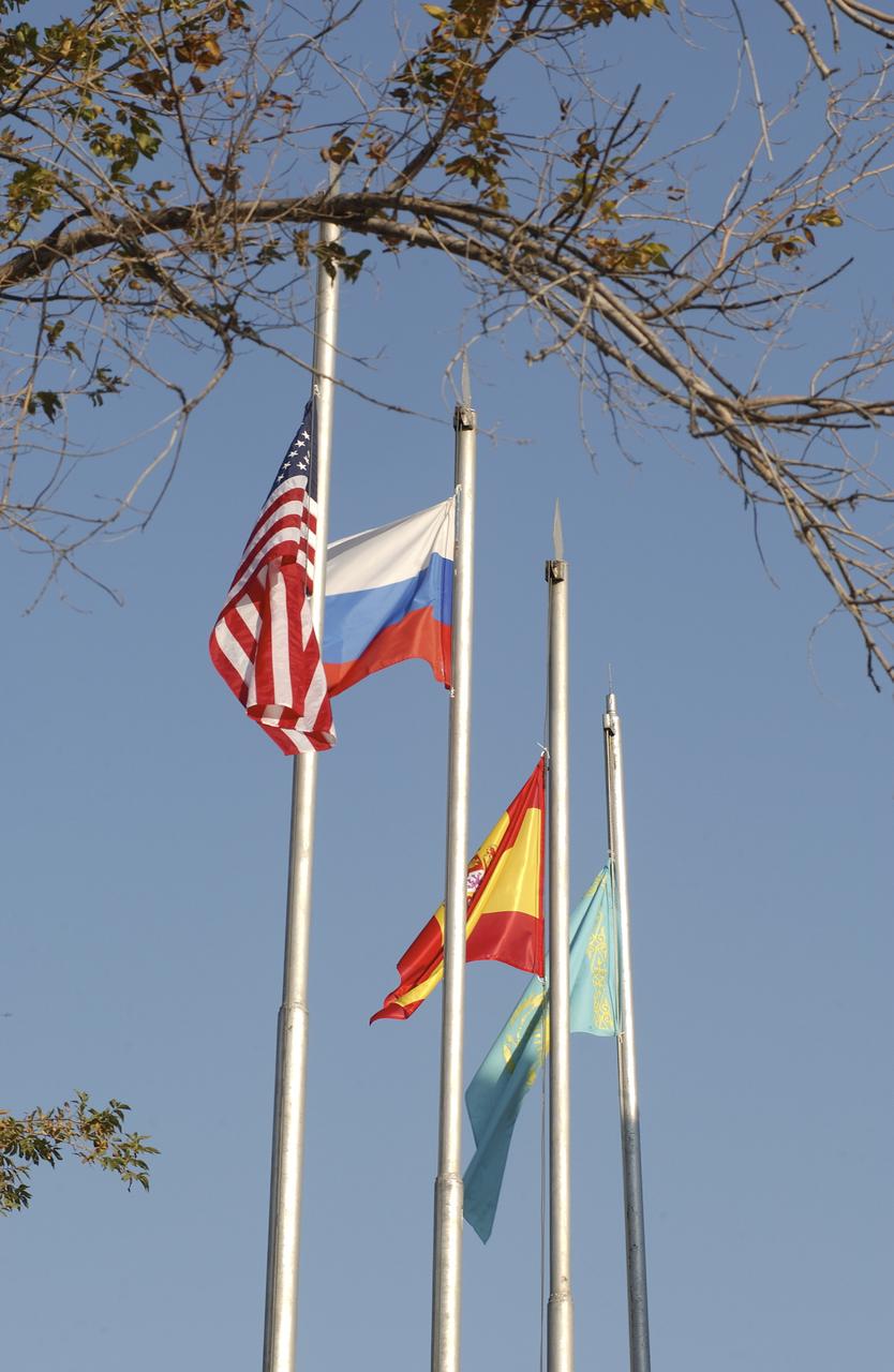 The flags of the United States, Russia, Spain and Kazakhstan fly outside the Cosmonaut Hotel, Tuesday, Oct. 14, 2003, in Baikonur, Kazakhstan following a traditional flag-raising ceremony. Photo Credit (NASA/Bill Ingalls)