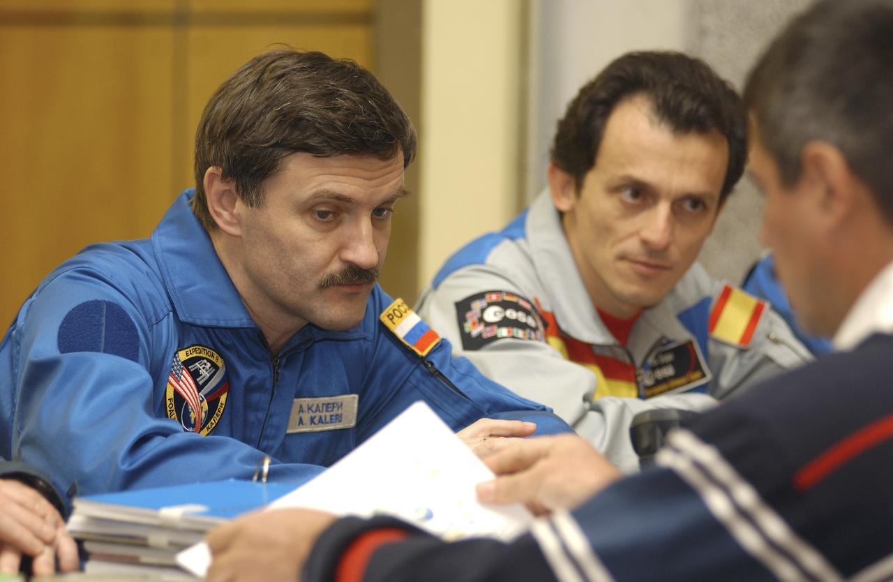 Expedition 8 Soyuz Commander and Flight Engineer Alexander Kaleri and European Space Agency astronaut Pedro Duque of Spain are briefed on launch procedures from a Russian trainer at their crew quarters in Baikonur, Kazakhstan, Wednesday, Oct. 15, 2003 as they prepare for launch Oct. 18 in a Soyuz TMA-3 vehicle to the International Space Station. Photo Credit (NASA/Bill Ingalls)