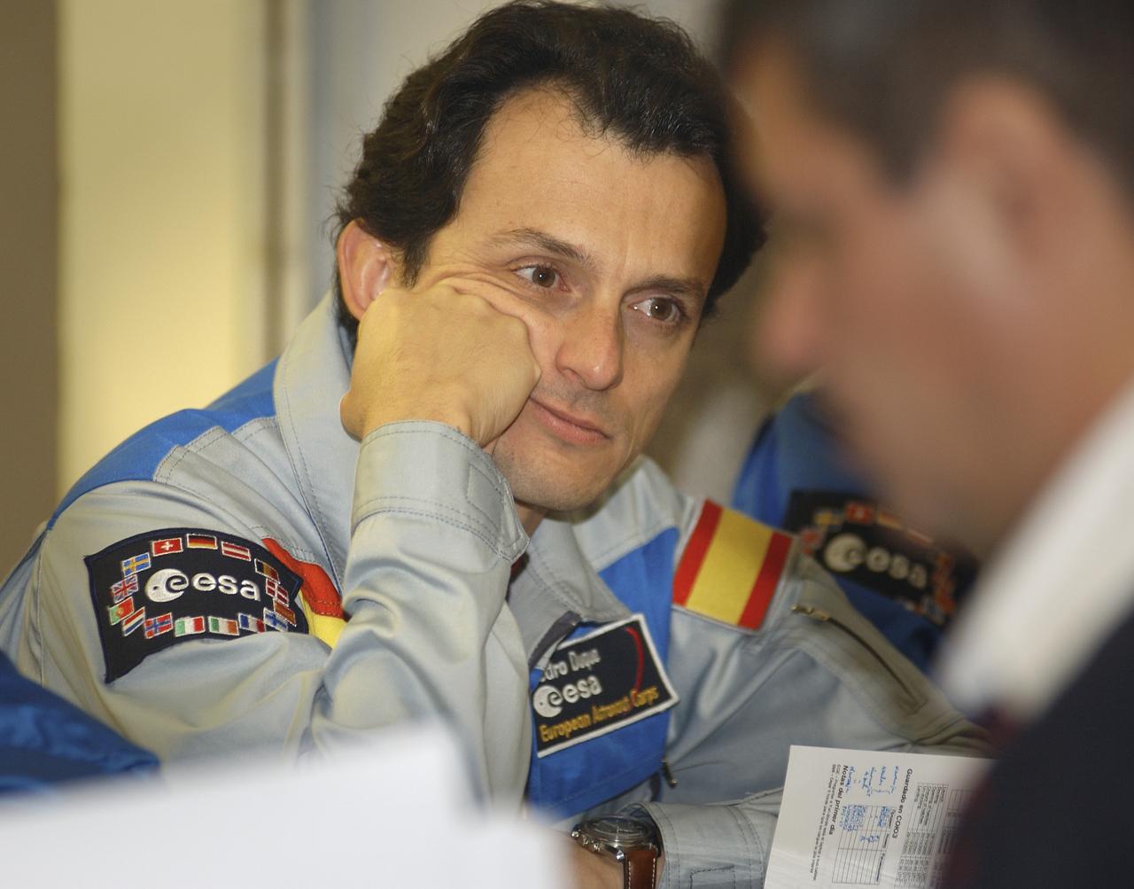 European Space Agency astronaut Pedro Duque of Spain listens to a briefing on mission activities from a Russian trainer at his crew quarters in Baikonur, Kazakhstan, Wednesday, Oct. 15, 2003 as he prepares for his launch to the International Space Station Oct. 18 in a Soyuz TMA-3 vehicle. Photo Credit (NASA/Bill Ingalls)
