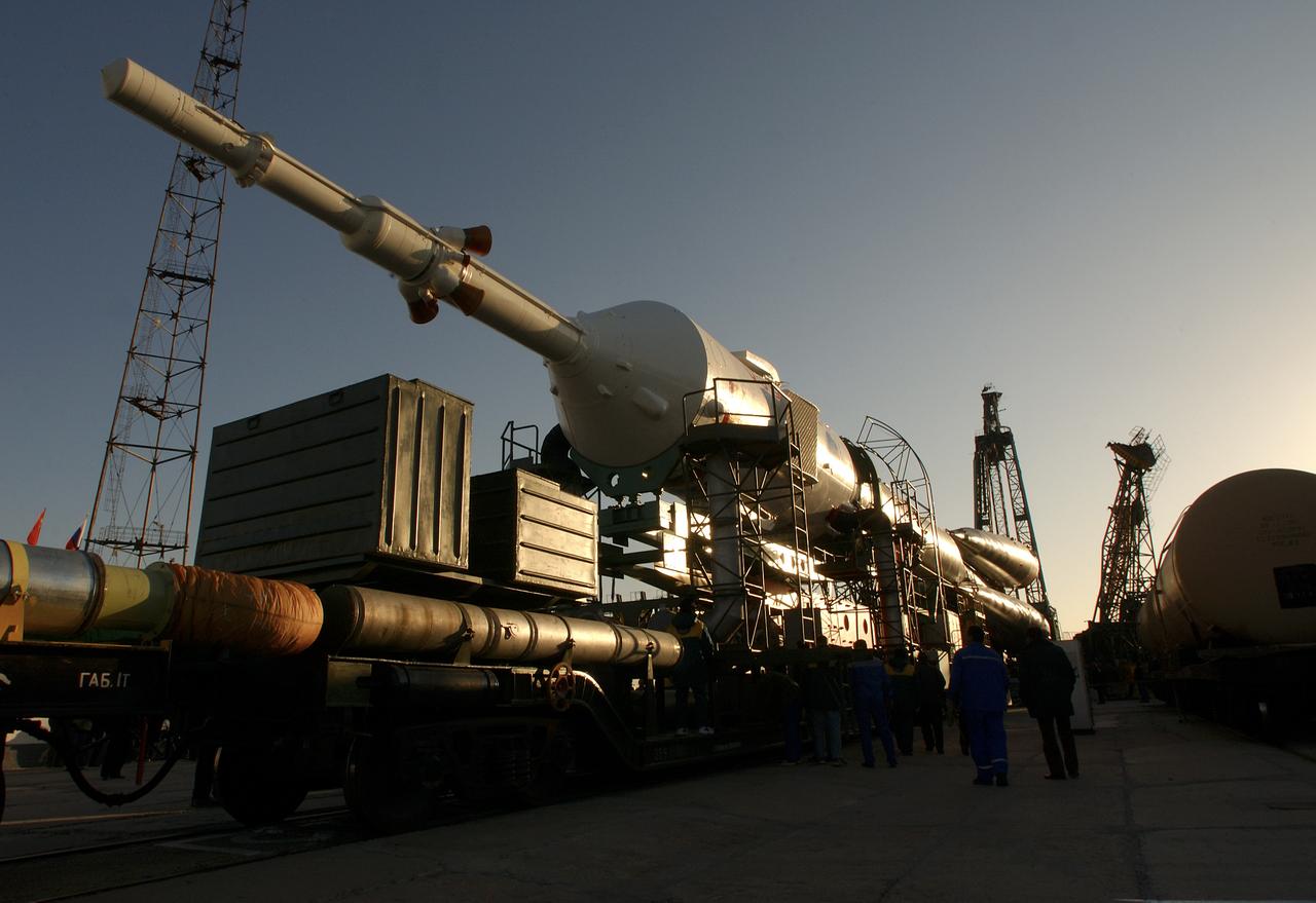 A Soyuz TMA-3 spacecraft and its booster rocket is seen, Thursday, Oct. 16, 2003, on a rail car near the launch pad at the Baikonur Cosmodrome, Kazakhstan during preparations for liftoff Oct. 18 to carry Expedition 8 Commander and NASA Science Officer Michael Foale, Expedition 8 Soyuz Commander Alexander Kaleri and European Space Agency astronaut Pedro Duque of Spain to the International Space Station. Photo Credit (NASA/Bill Ingalls)